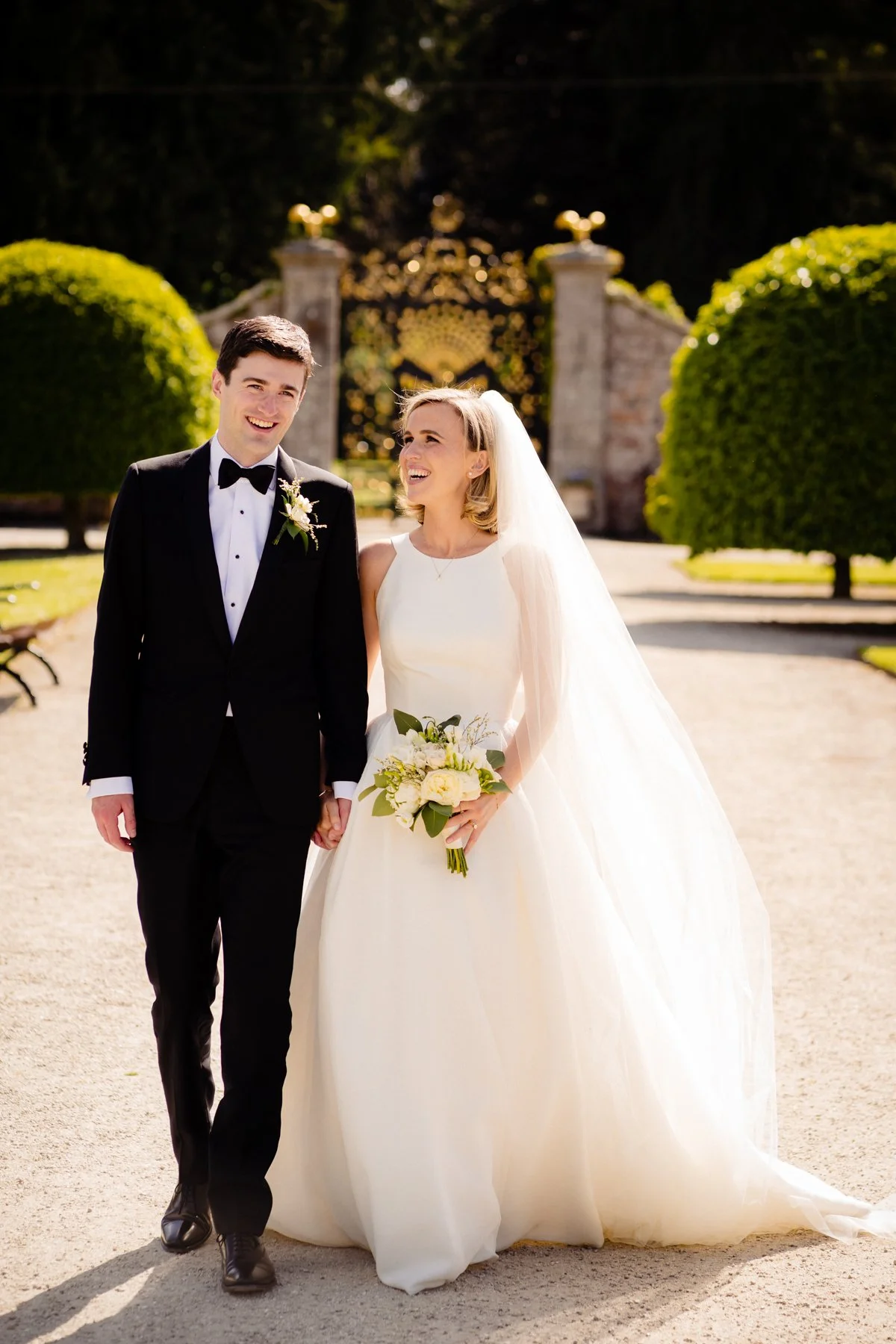 A classic black tie wedding portrait of the happy bride and groom at their Powerscourt Estate wedding