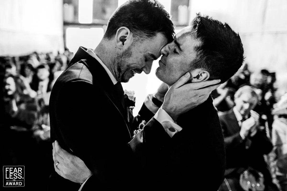 An intimate moment between two grooms during their same sex wedding ceremony at CloughJordan House as they embrace after the first kiss.