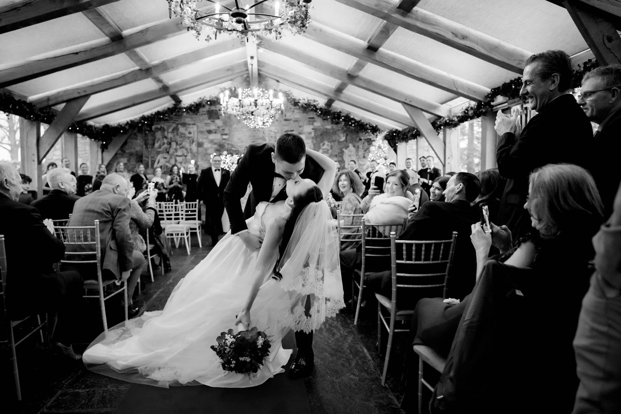 Barberstown Castle wedding photographer captures groom dipping bride after first kiss in conservatory ceremony room