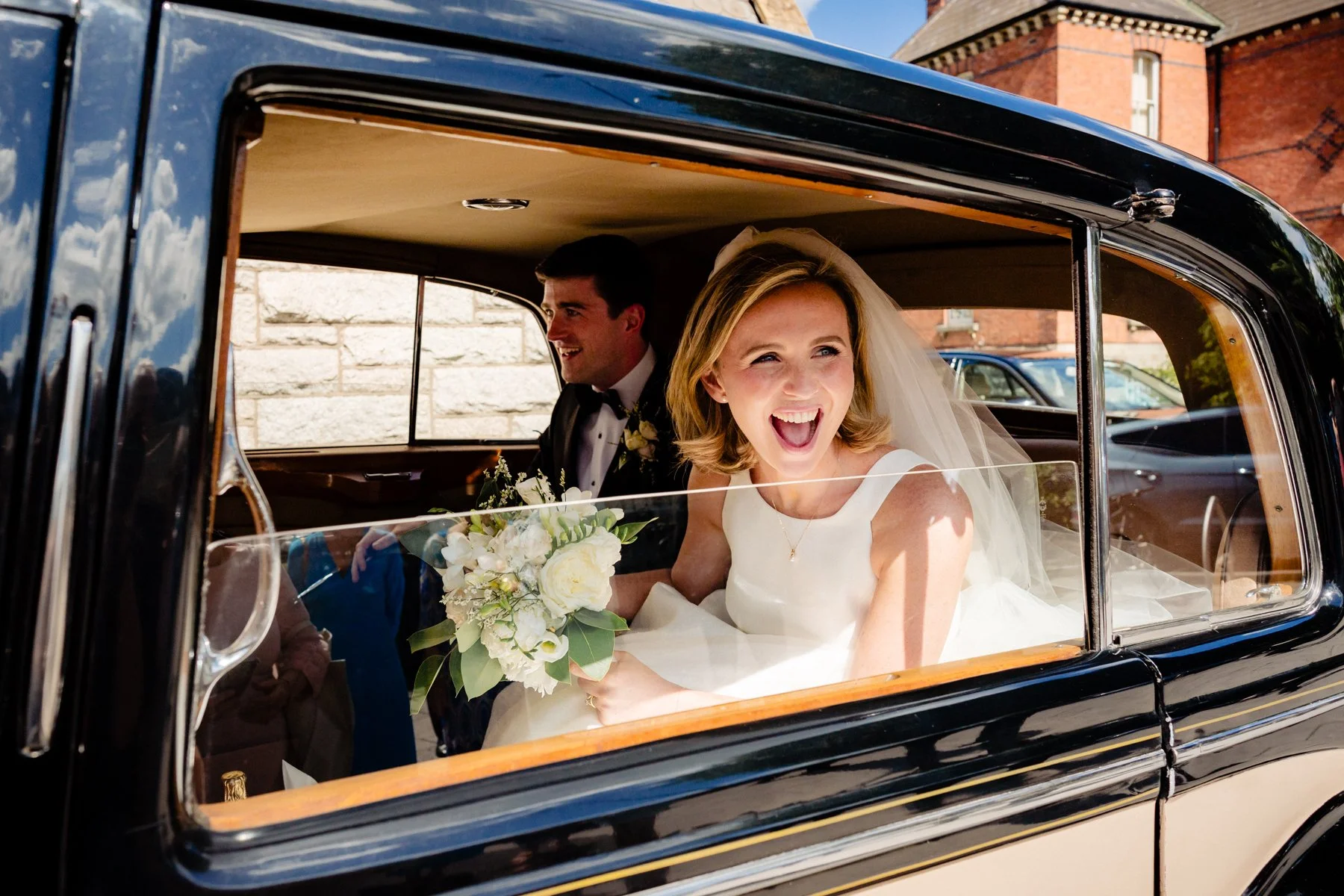 Documentary style wedding photography of the happy bride on the way to her wedding reception in Powerscourt Estate
