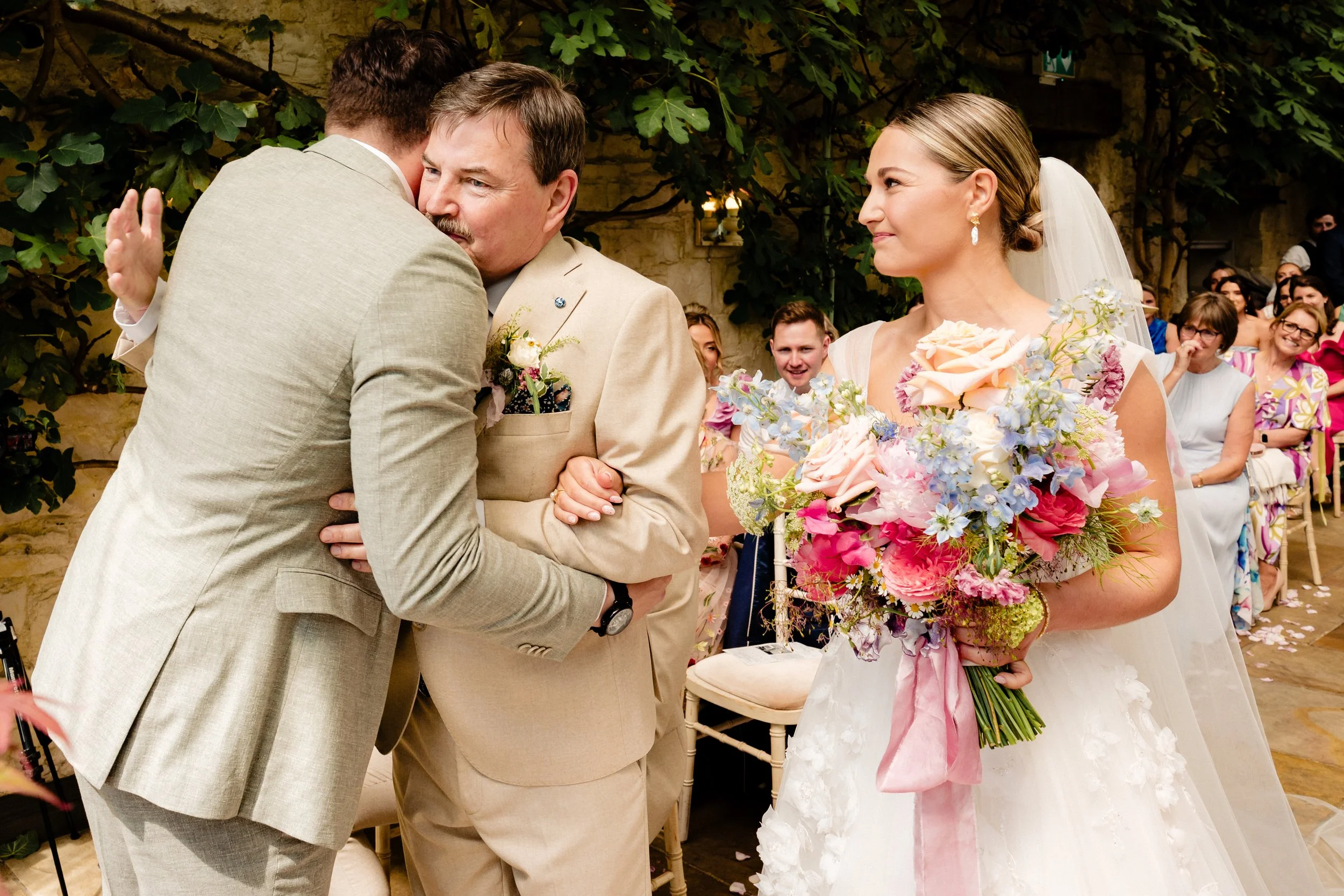 A classic wedding photography moment of the hand over of the bride at a summer wedding in the Cliff at Lyons