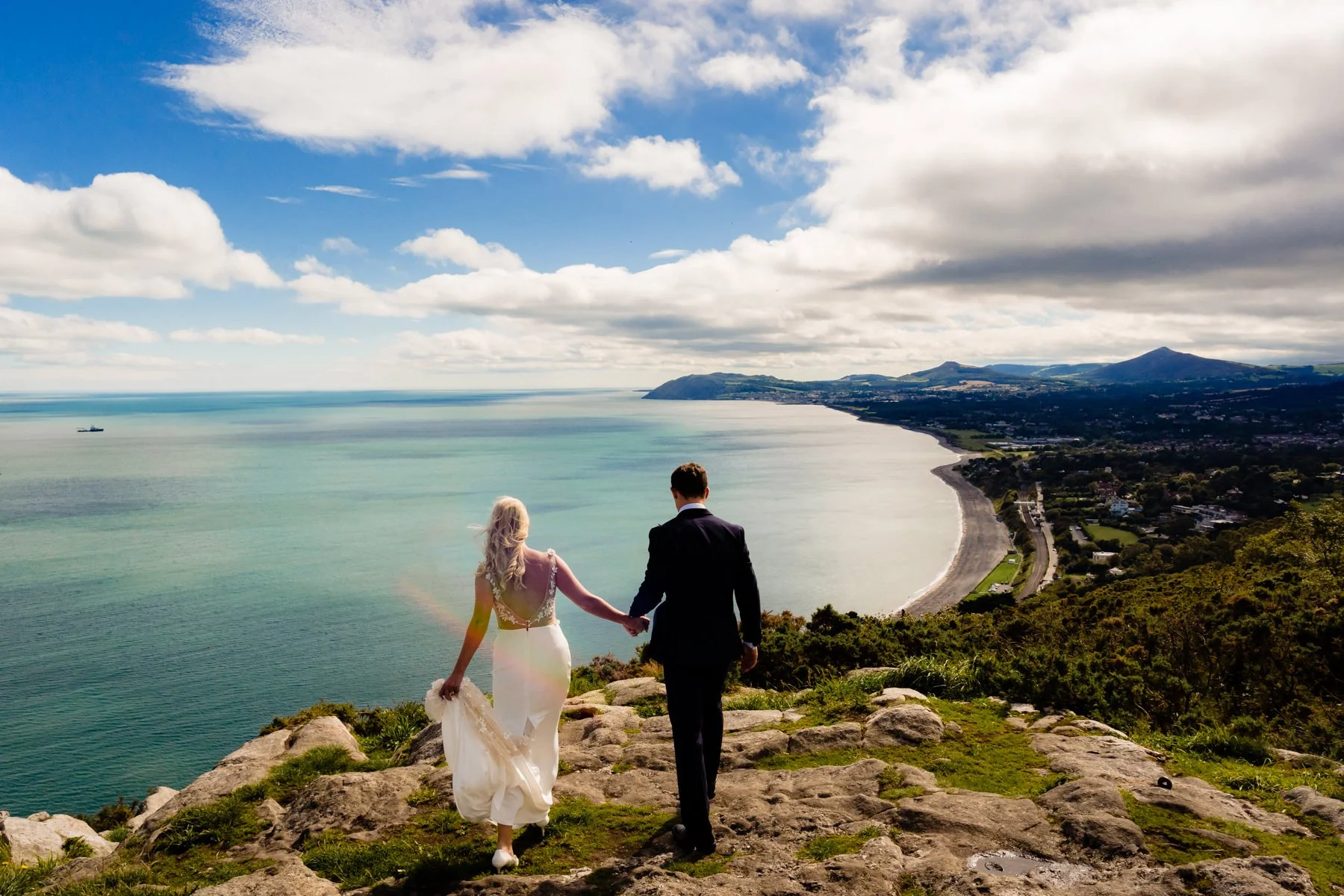 Wedding photographer Annie Kheffache captures the bride and groom enjoying the view of Dublin bay in this Dublin wedding portrait