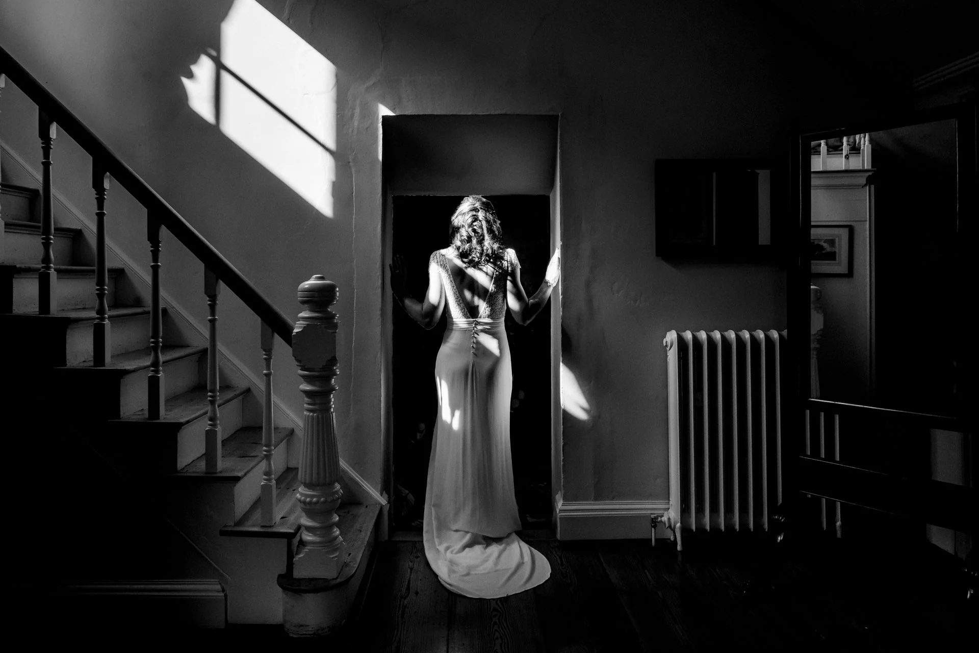 Documentary style portrait of the bride as she leaves the bridal suite at Gloster House for her outdoor wedding on the lawn at Gloster