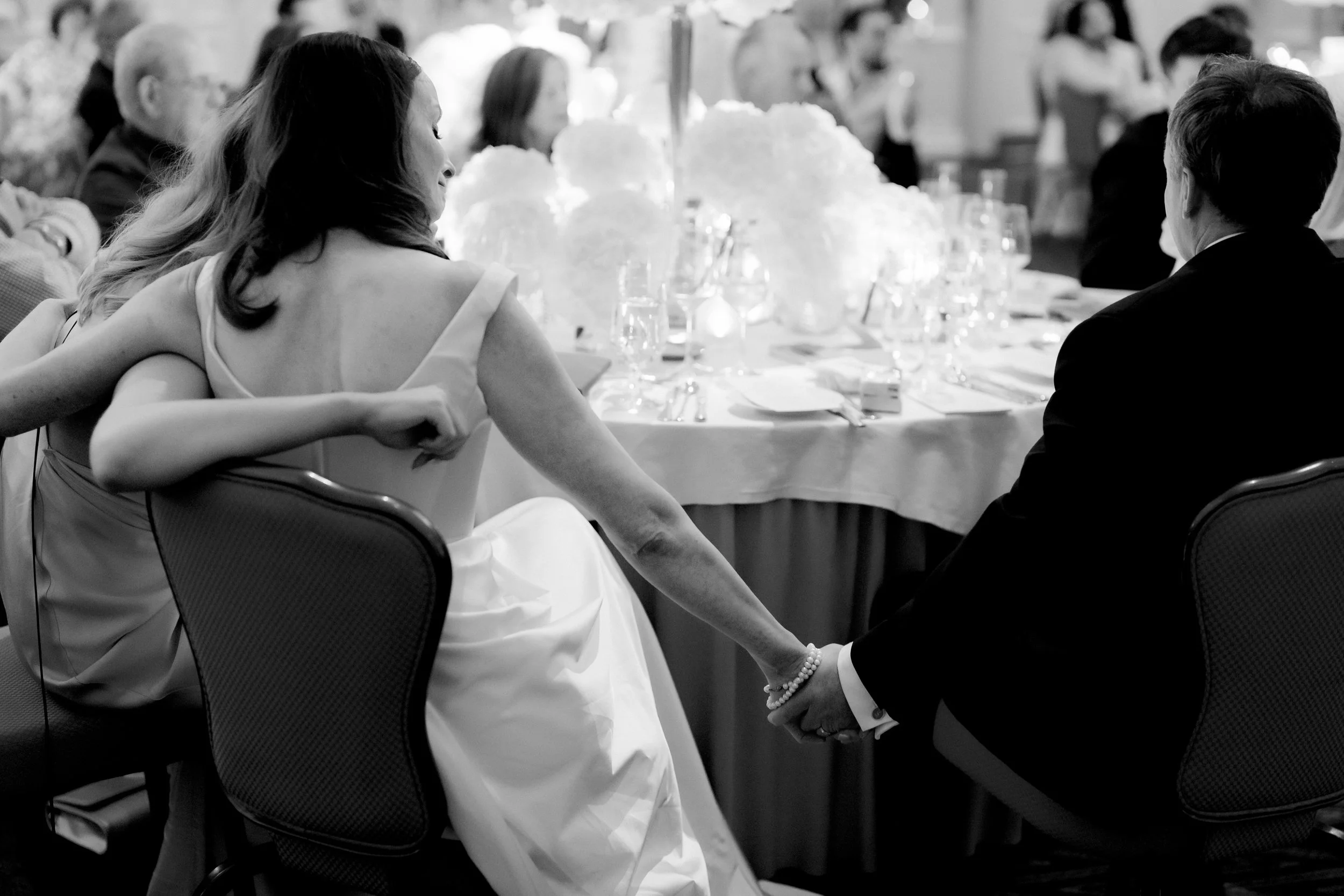 A quiet moment during the speeches at a Shelbourne Hotel Dublin wedding caught by a documentary style wedding photographer
