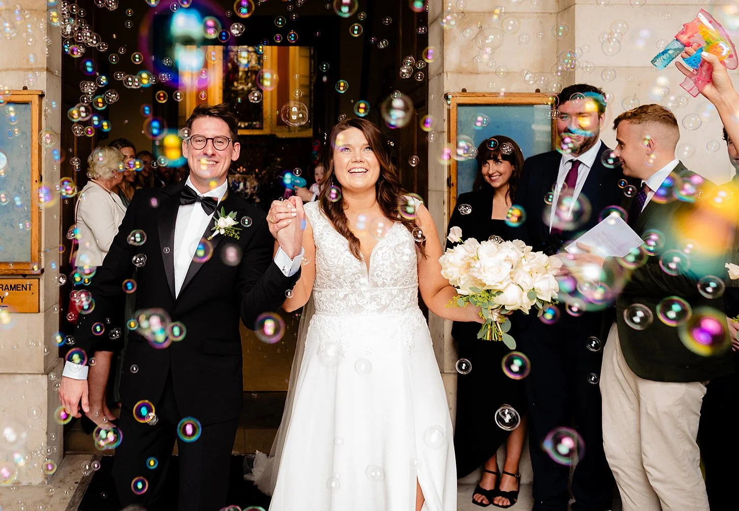 Black tie wedding photography of a couple with a bubble exit at their Trinity College Dublin wedding