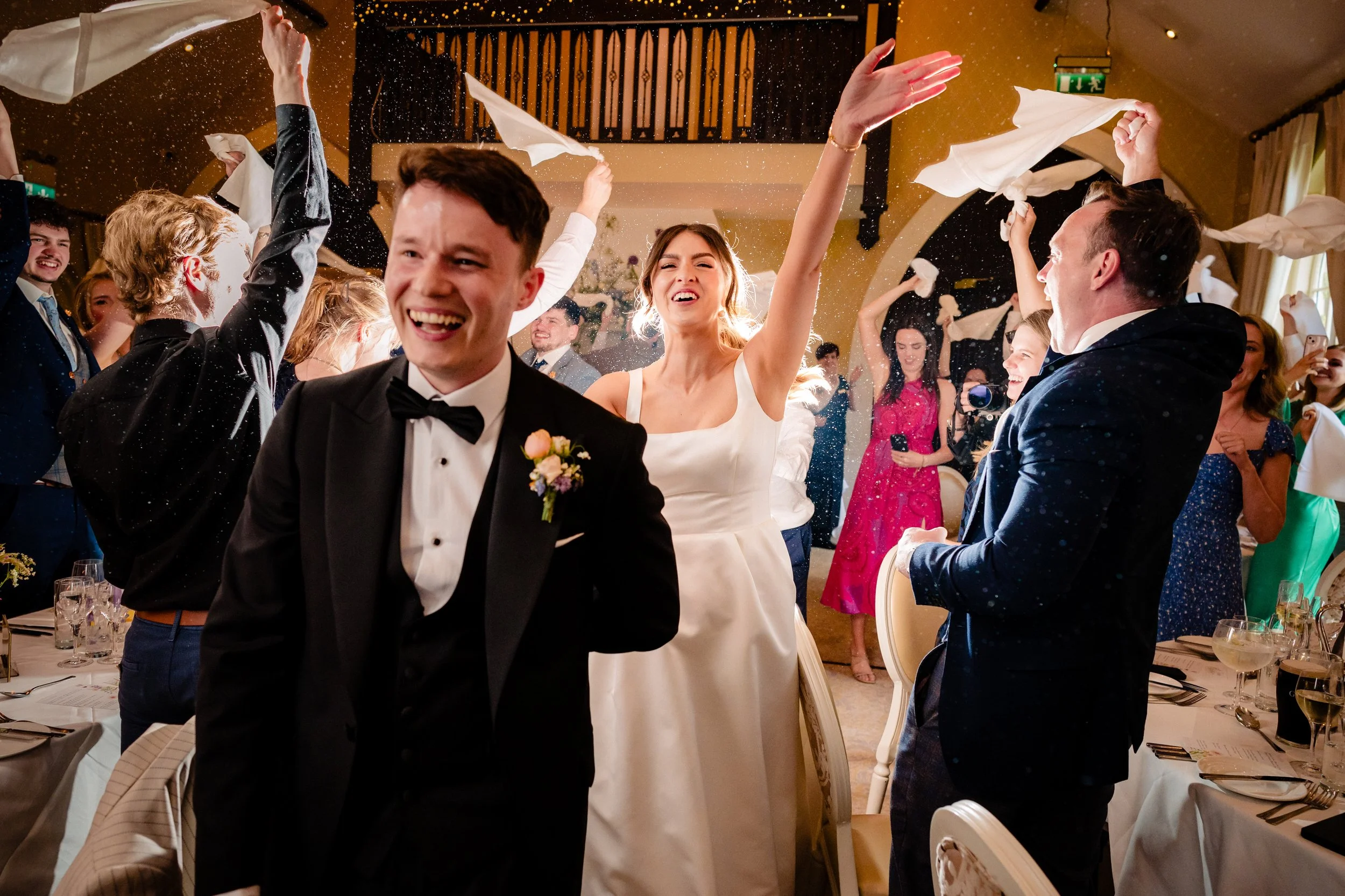 BrookLodge wedding photographer Annie Kheffache creates photograph of joyful real moment of the couple surrounded by happy guests in BrookHall