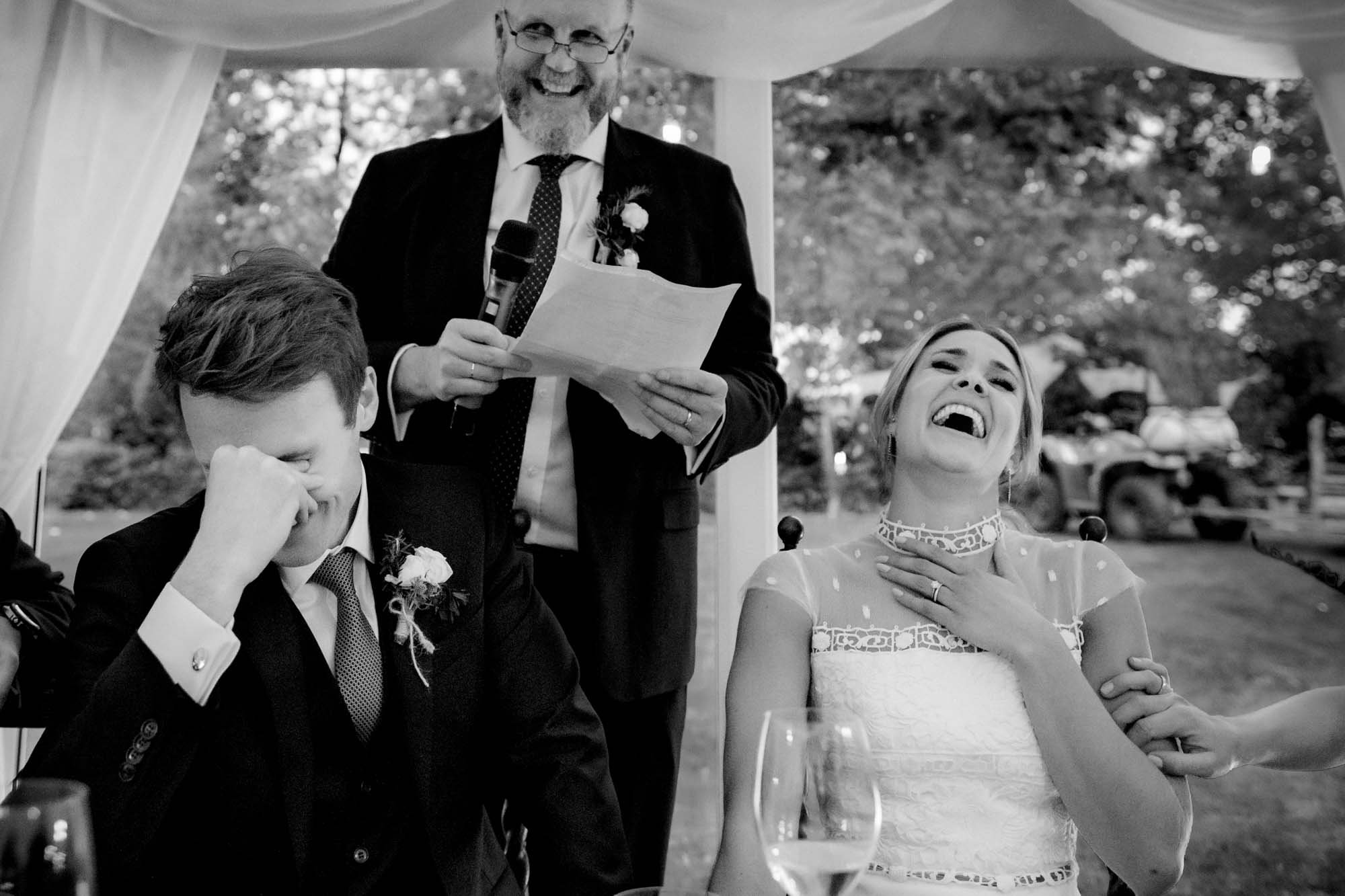 Black and white wedding photograph of the speeches in the dining room at CloughJordan House