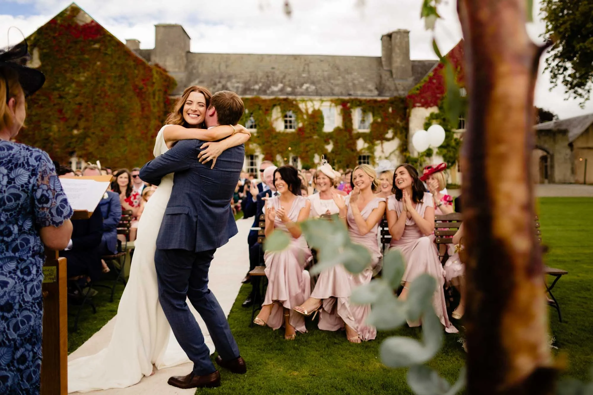 A joyous moment of celebration for the bride and groom at an outdoor wedding ceremony at CloughJordan House