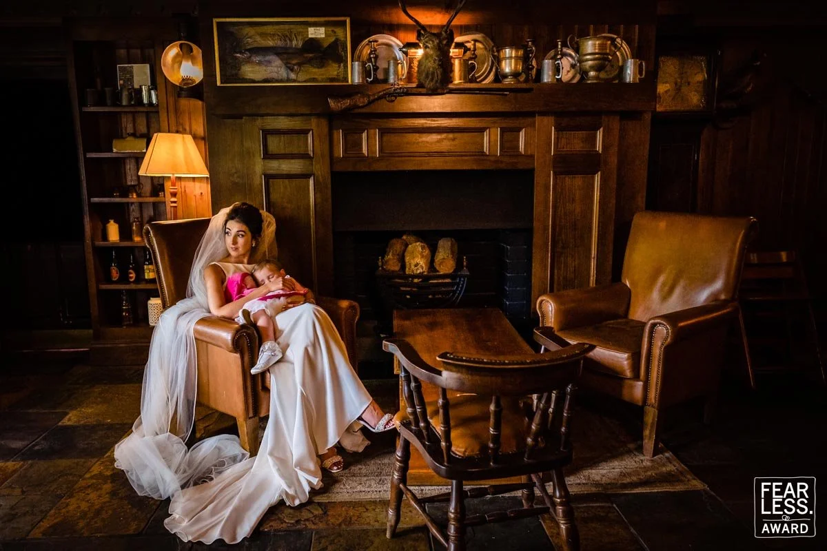Natural wedding photography of the bride holding her little girl at a small intimate wedding at BrookLodge