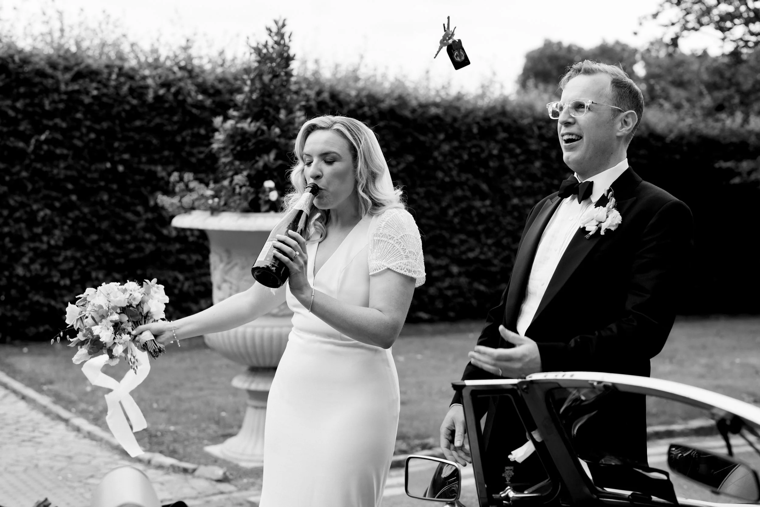 Natural moment wedding photography of the bride and groom arriving for their black tie wedding in Cliff at Lyons