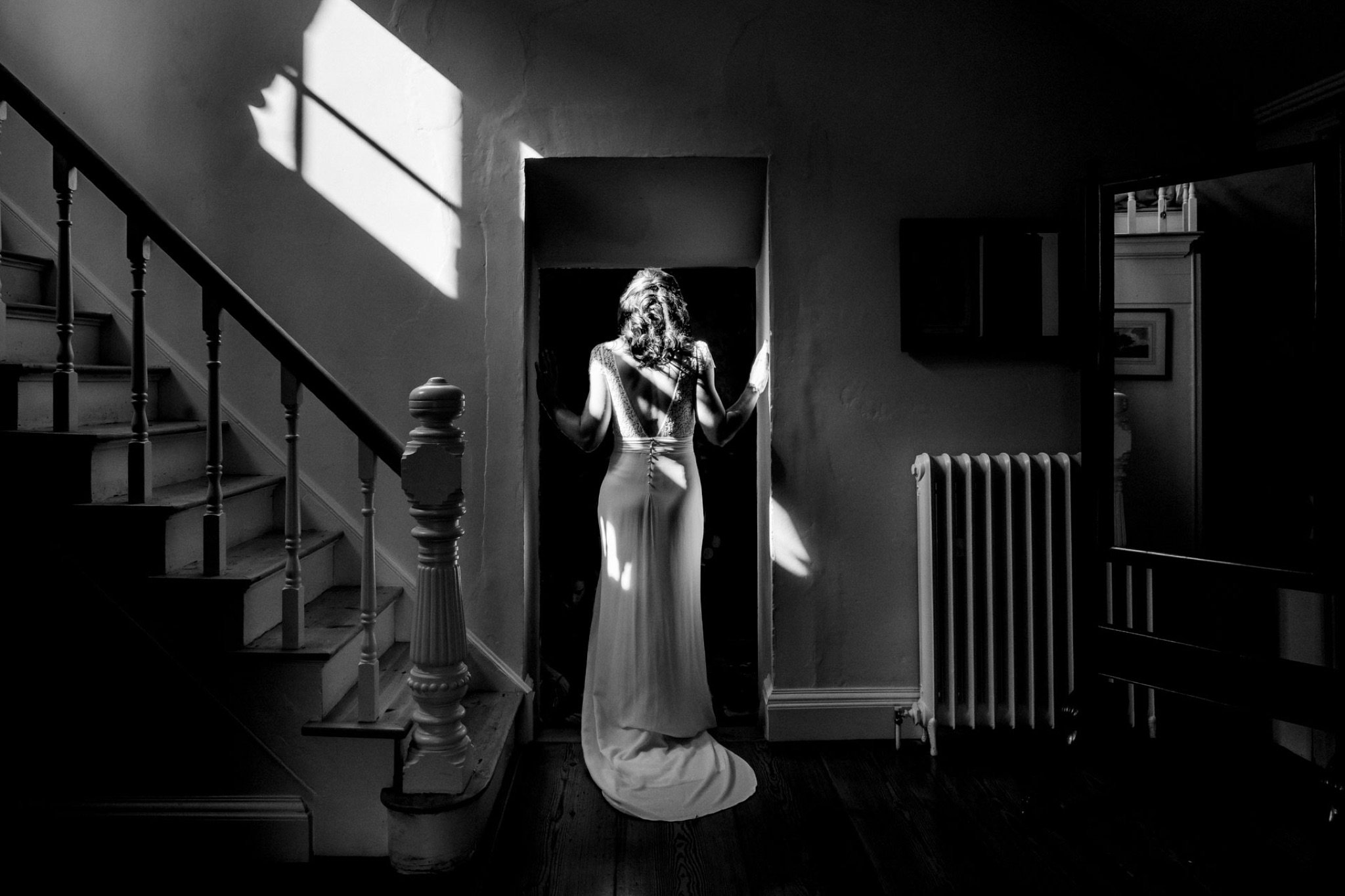 steaks of light htting the back of a bride in black and white
