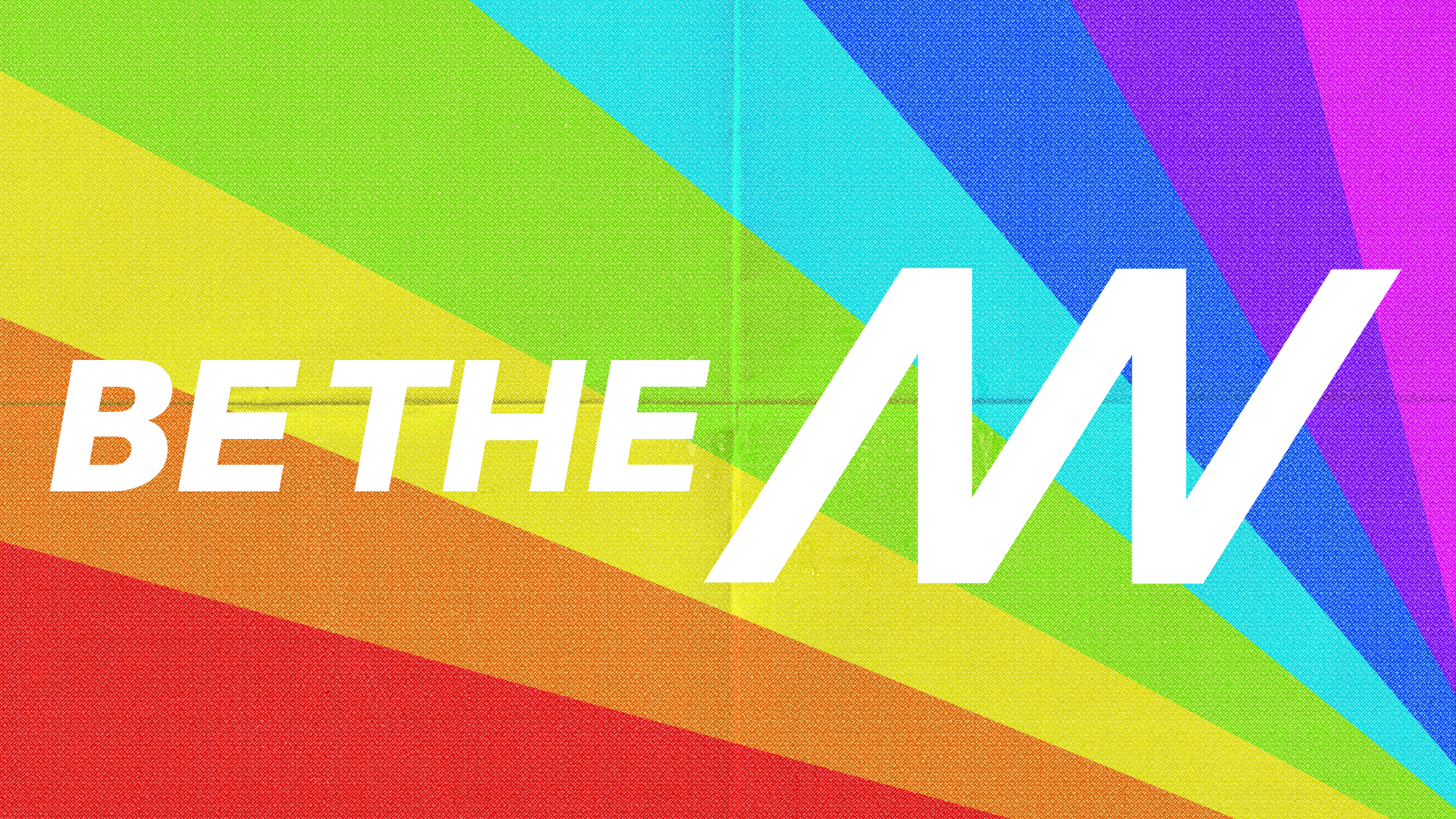 Colorful rainbow background overlaid with the white text 'BE THE ENVY'.