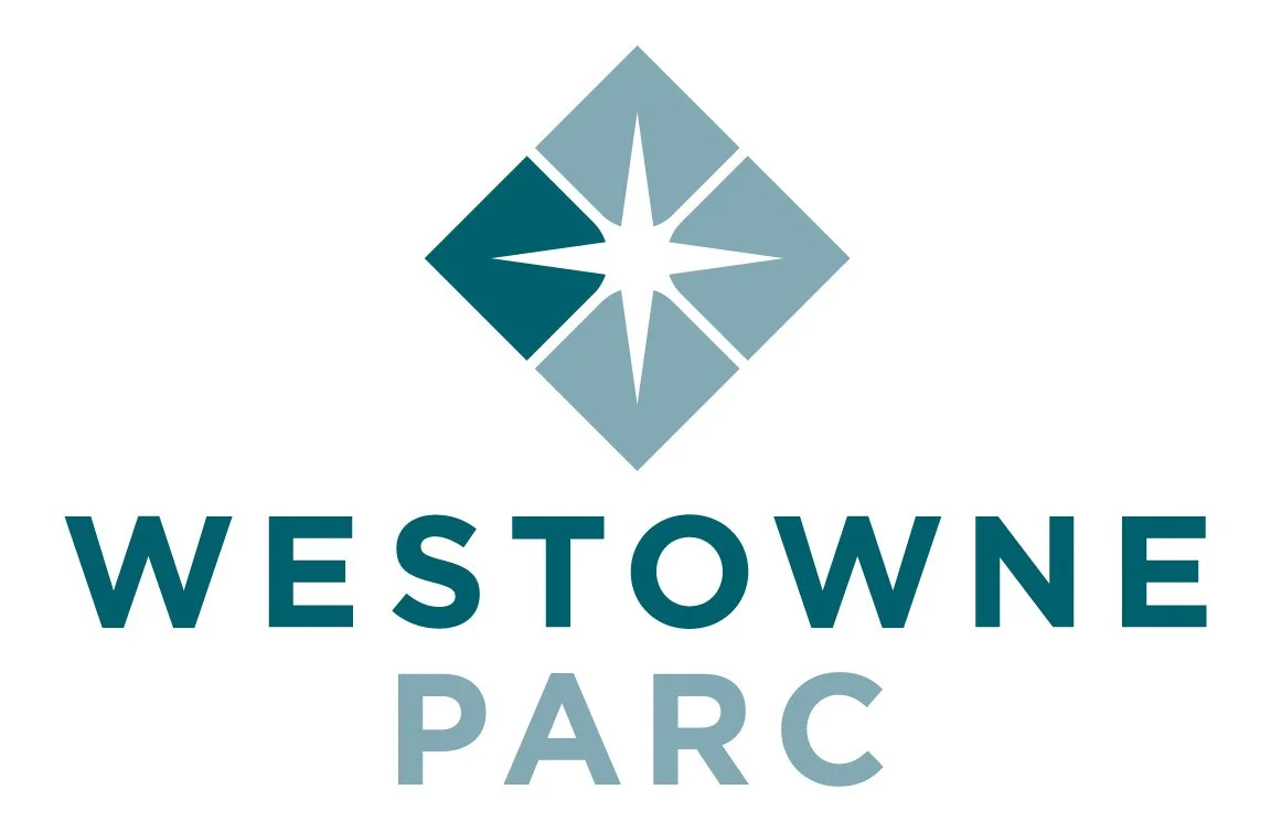 The logo of Westowe Parc featuring a stylized compass rose within a diamond shape, with the name written below in blue and gray text.