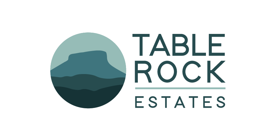 Logo for Table Rock Estates featuring stylized mountain rock formation in a circle and text