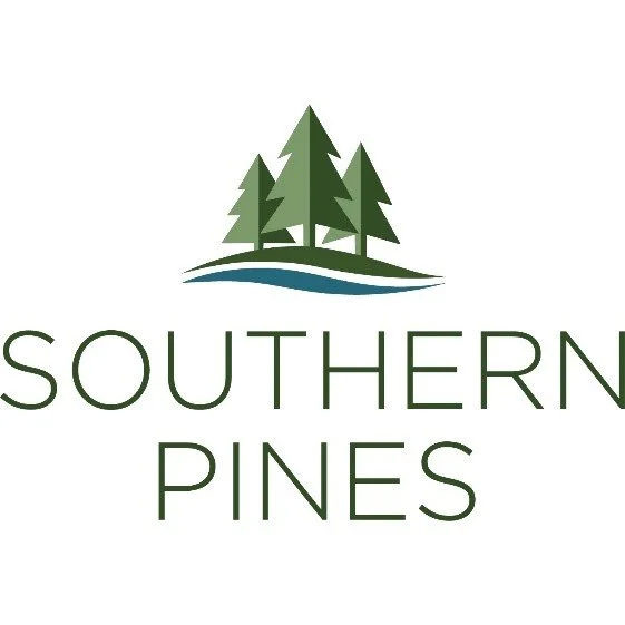 Logo for Southern Pines featuring stylized green pine trees above a blue line and the text "Southern Pines" below.
