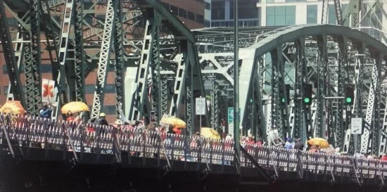 Hundreds of local residents march across the Hawthorne Bridge