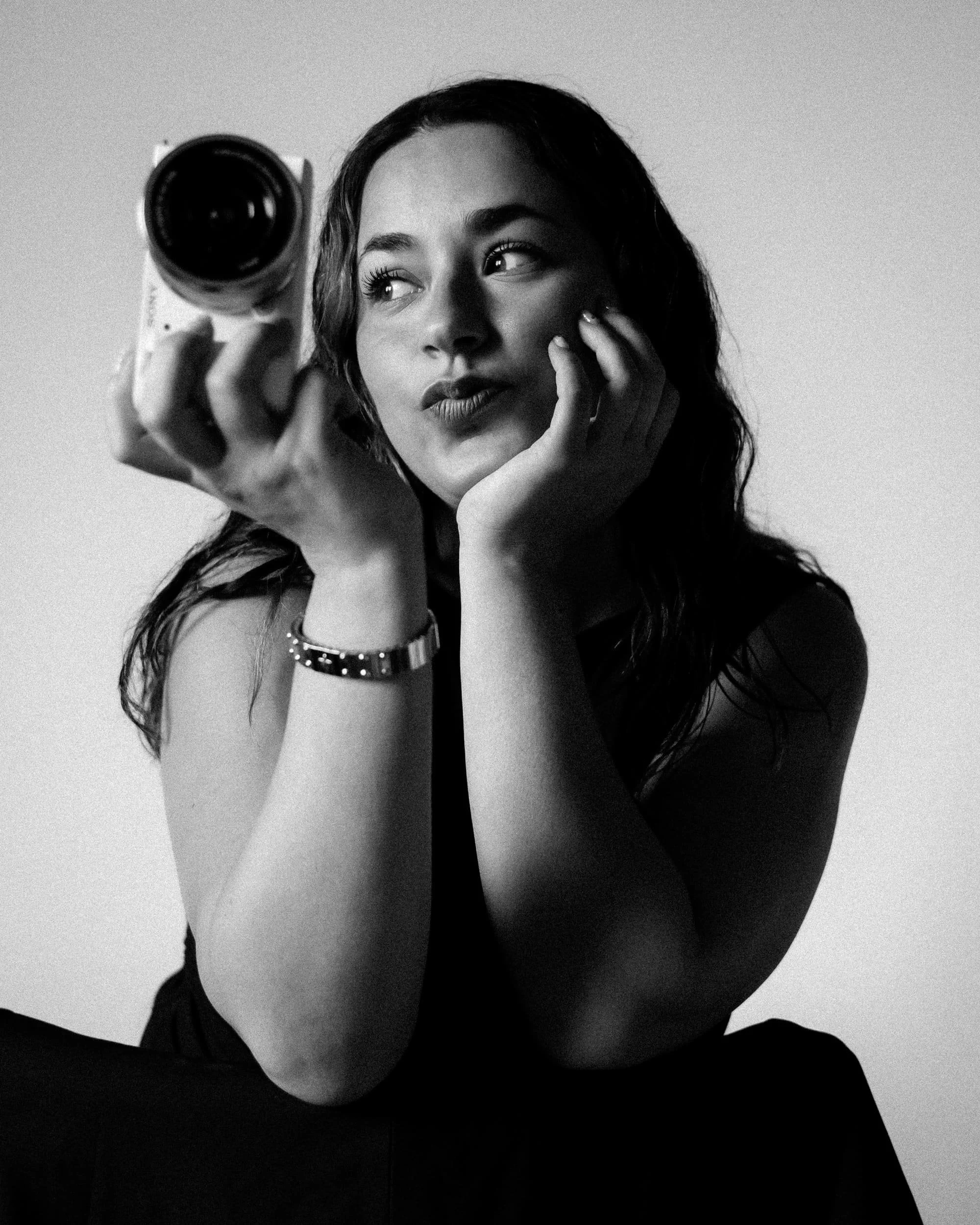 A creative brand photograph of Pao Villas posing with a camera in her hand