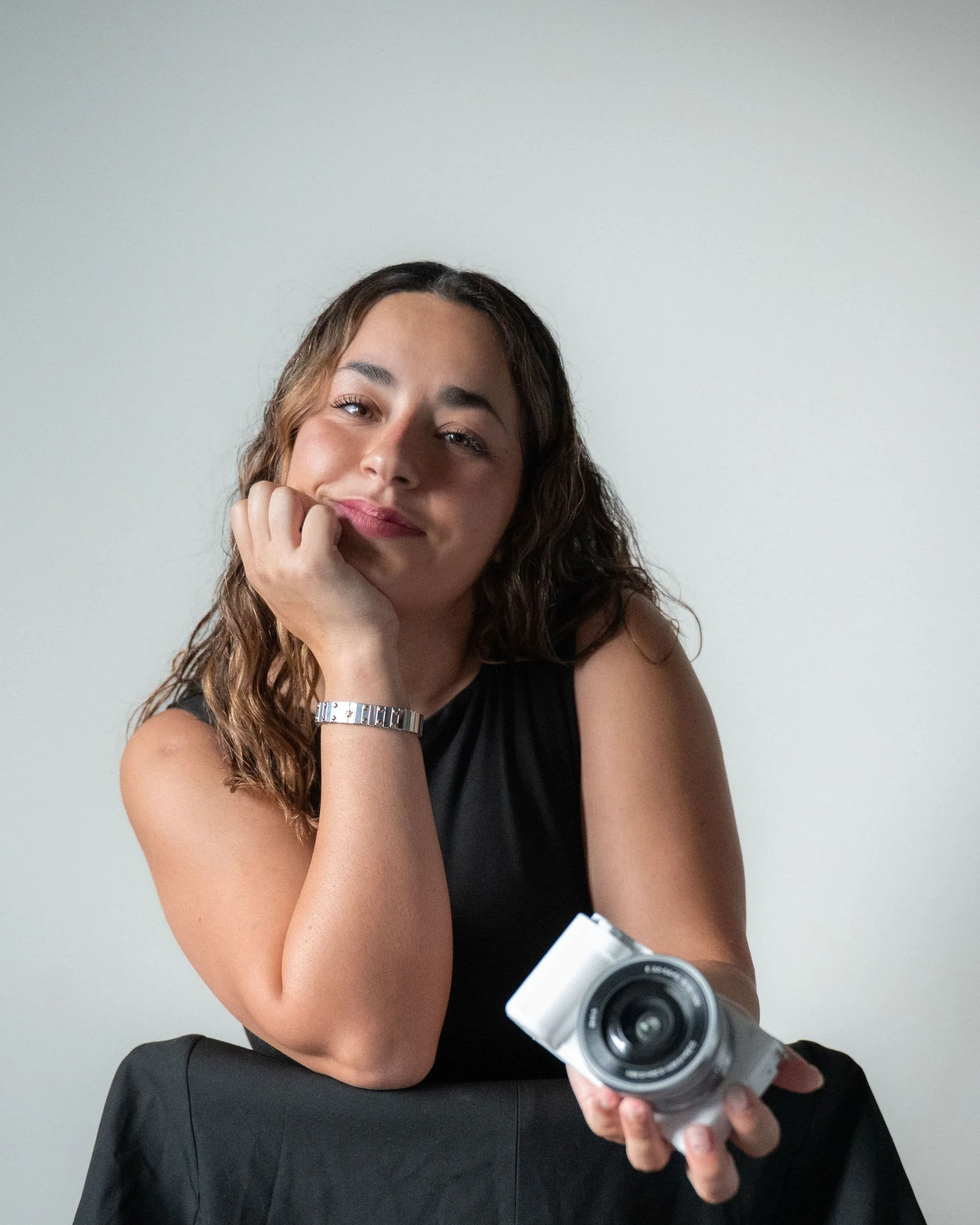 Pao Villas, founder of Dot Creative, posing with her camera for her brand photoshoot