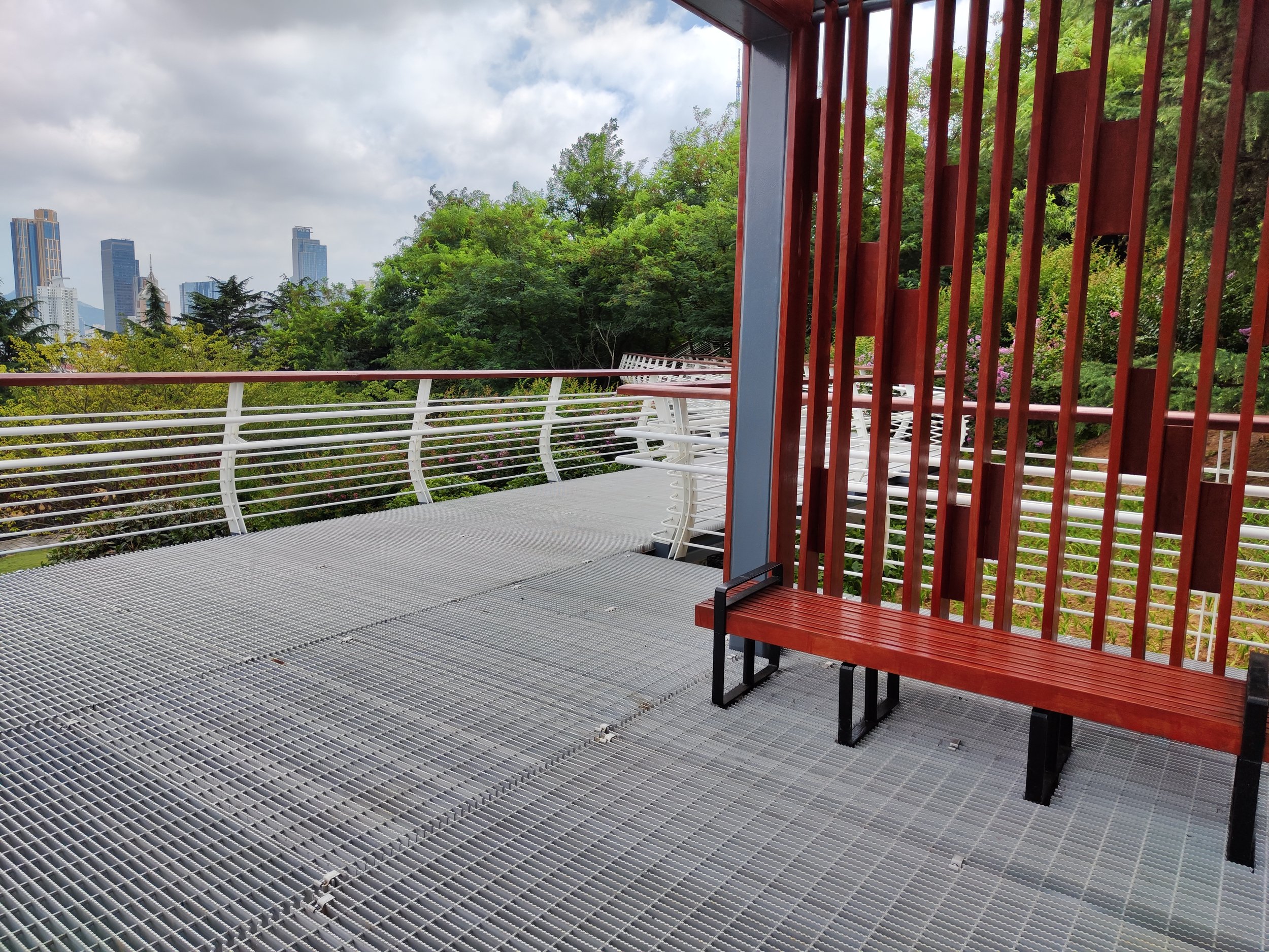 Close-up view of a modern glass building with horizontal and vertical lines, against a bright blue sky.