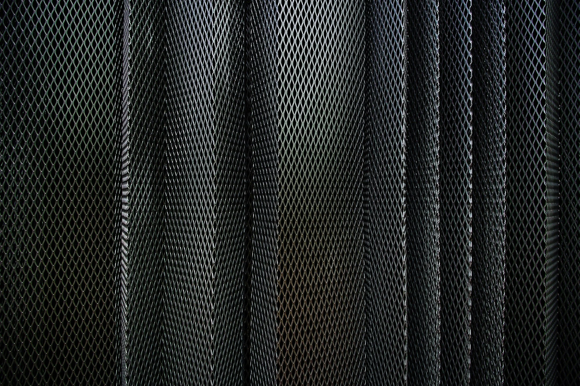 Close-up of black metal mesh panels or grates.