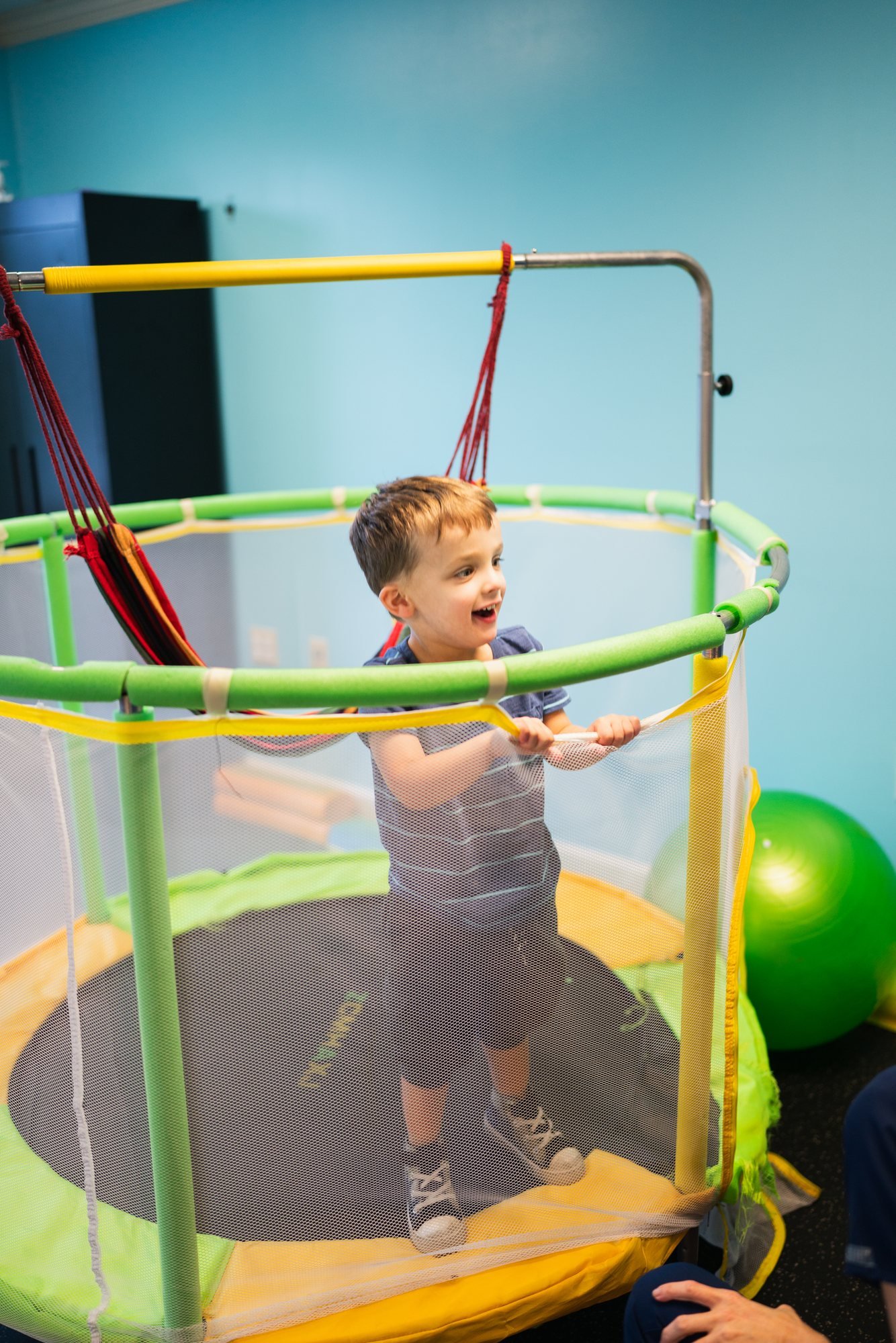 A child bouncing on the trampoline in the sensory gym at StarBright Centers in Maryville, TN.