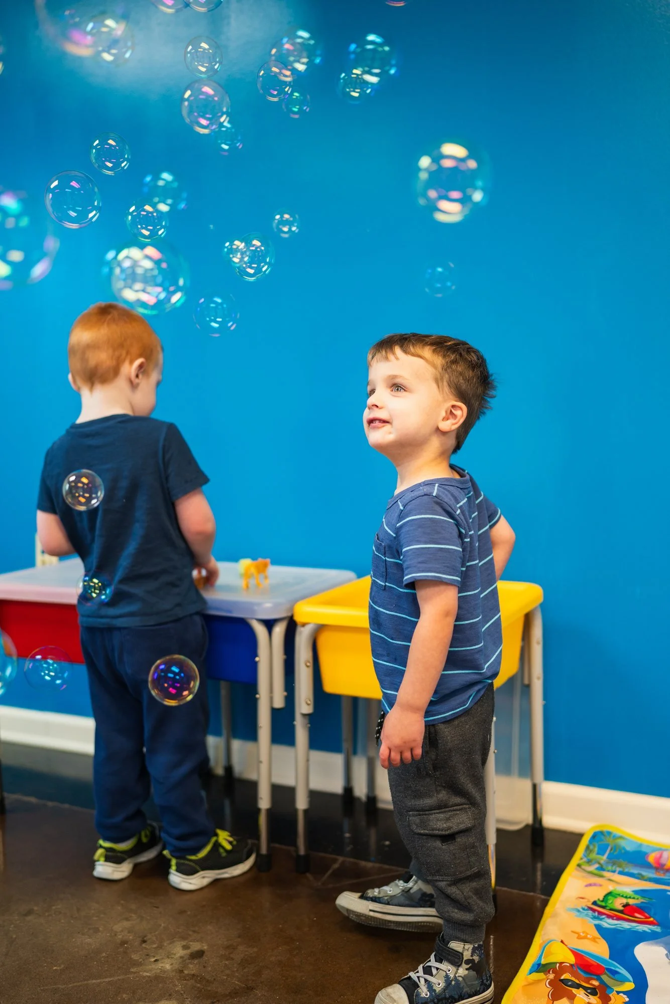 Two children playing with bubbles at StarBright Centers