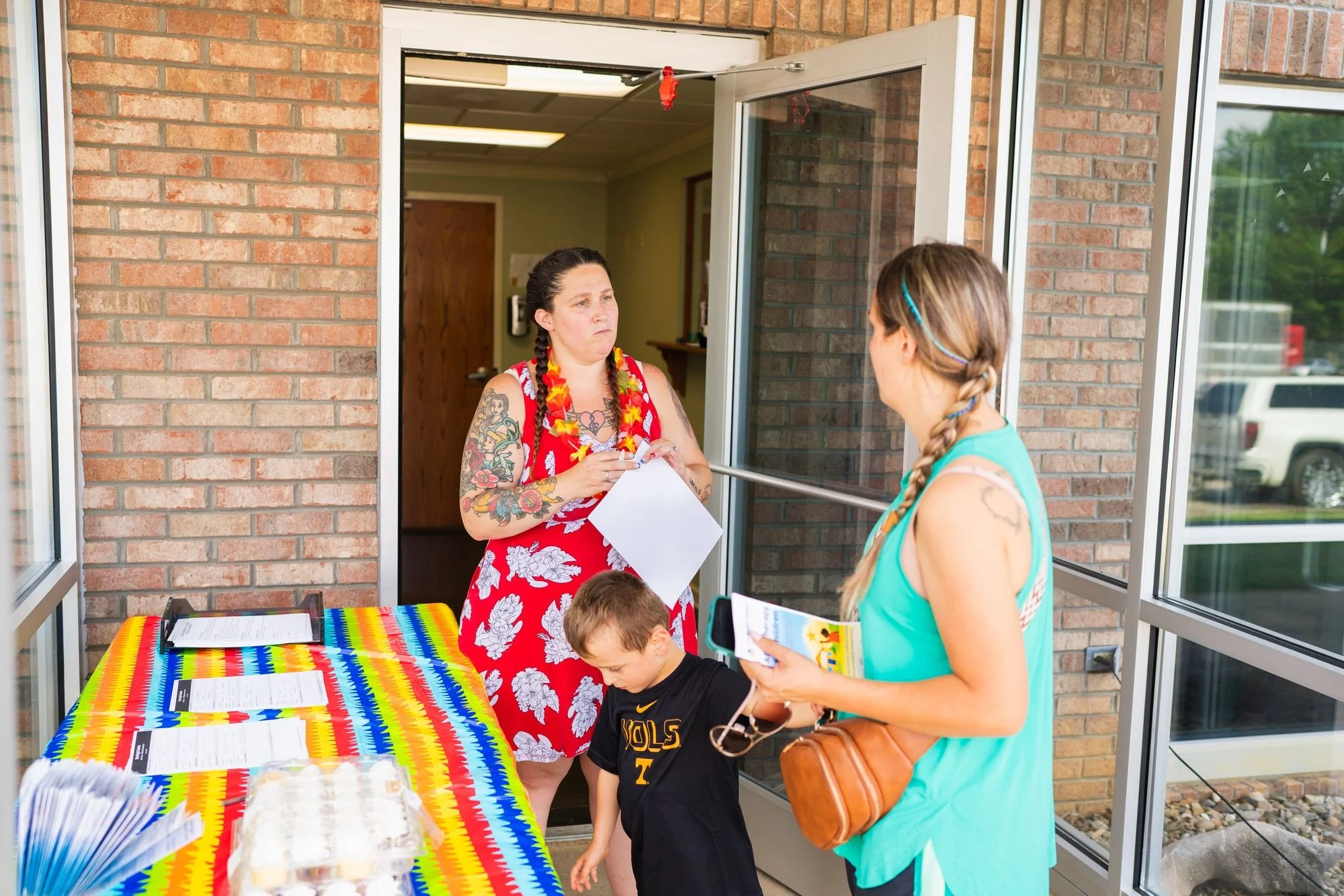 StarBright Centers team member talking with a parent at the clinic entrance