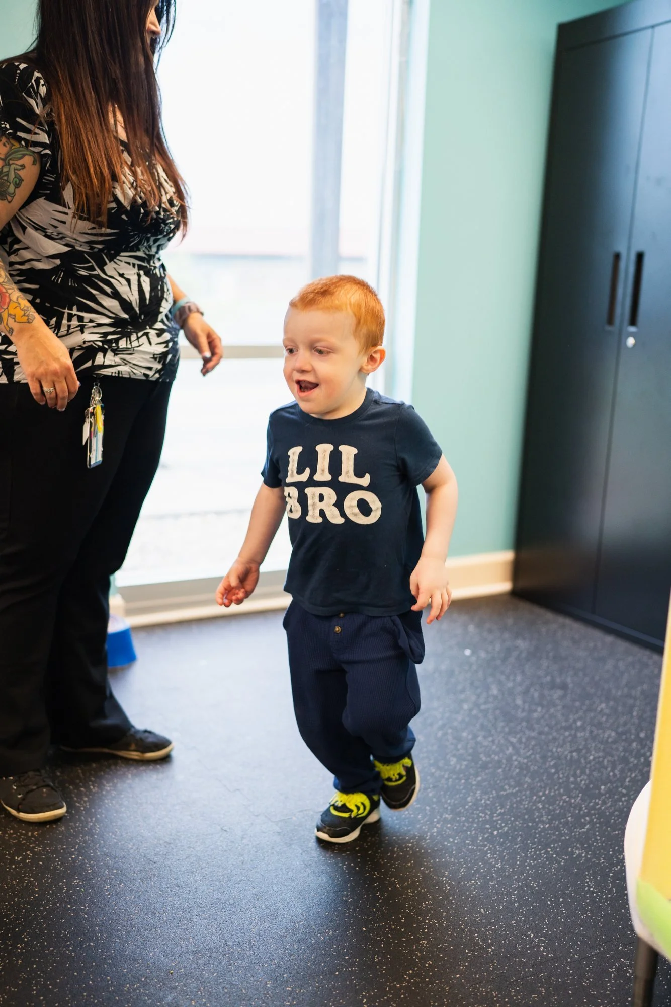A child running and smiling in the sensory gym at StarBright Centers in Maryville, TN.