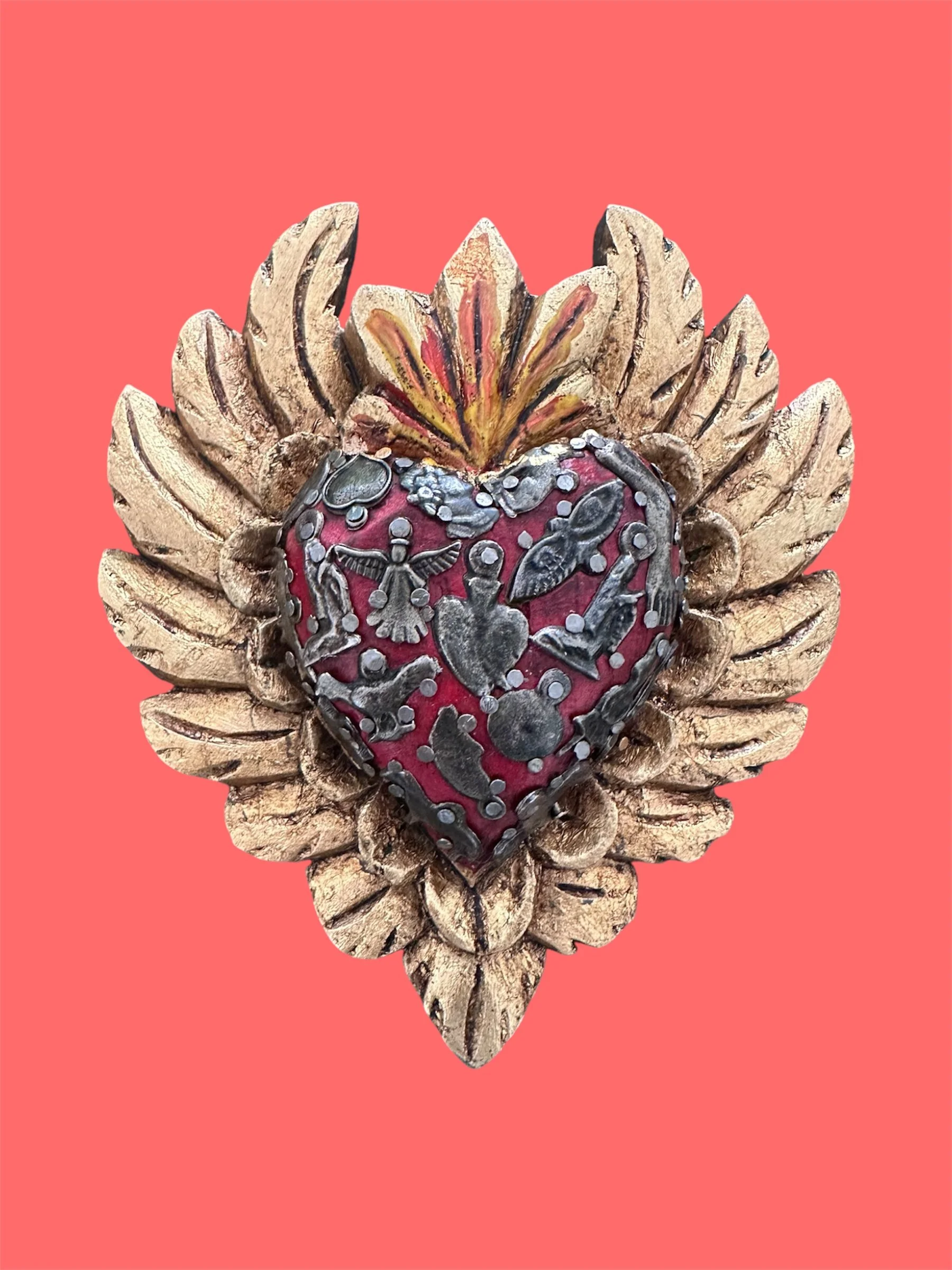 Decorative Mexican milagrito heart with wooden wings handmade in Mexico.