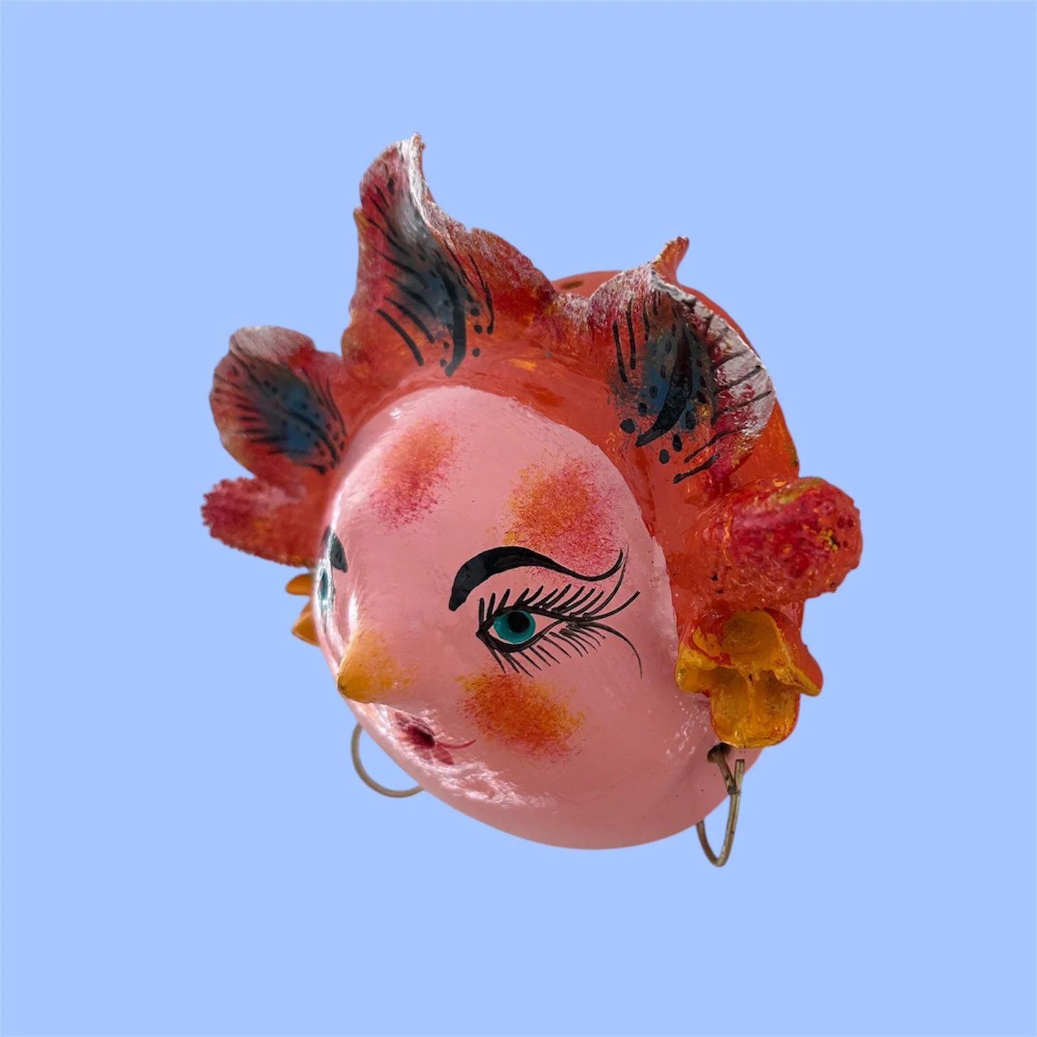 Side view of a handcrafted Mexican coconut mask featuring a woman with leaves.