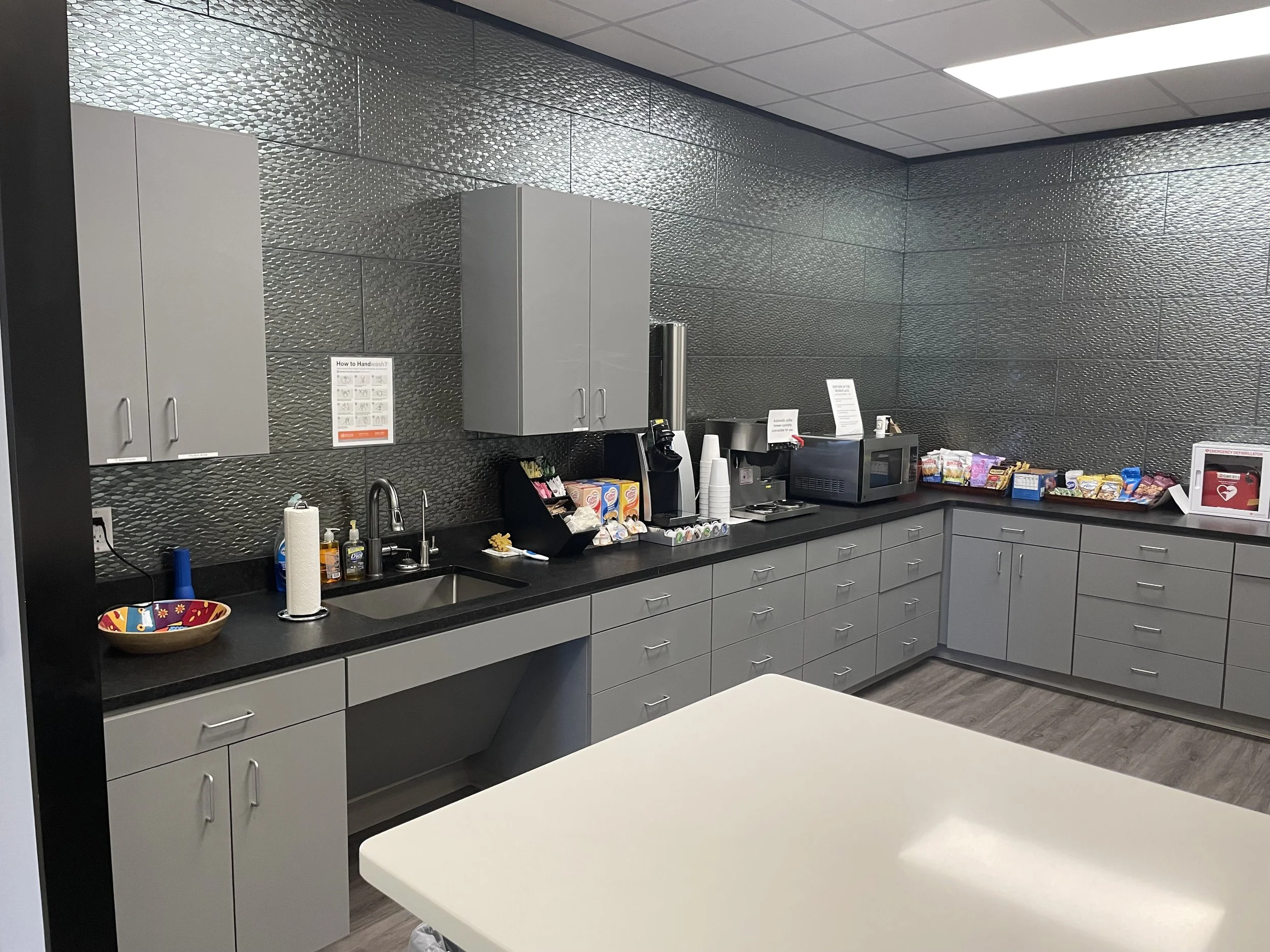 New cabinets, countertop, and backsplash create a clean and durable staff area.