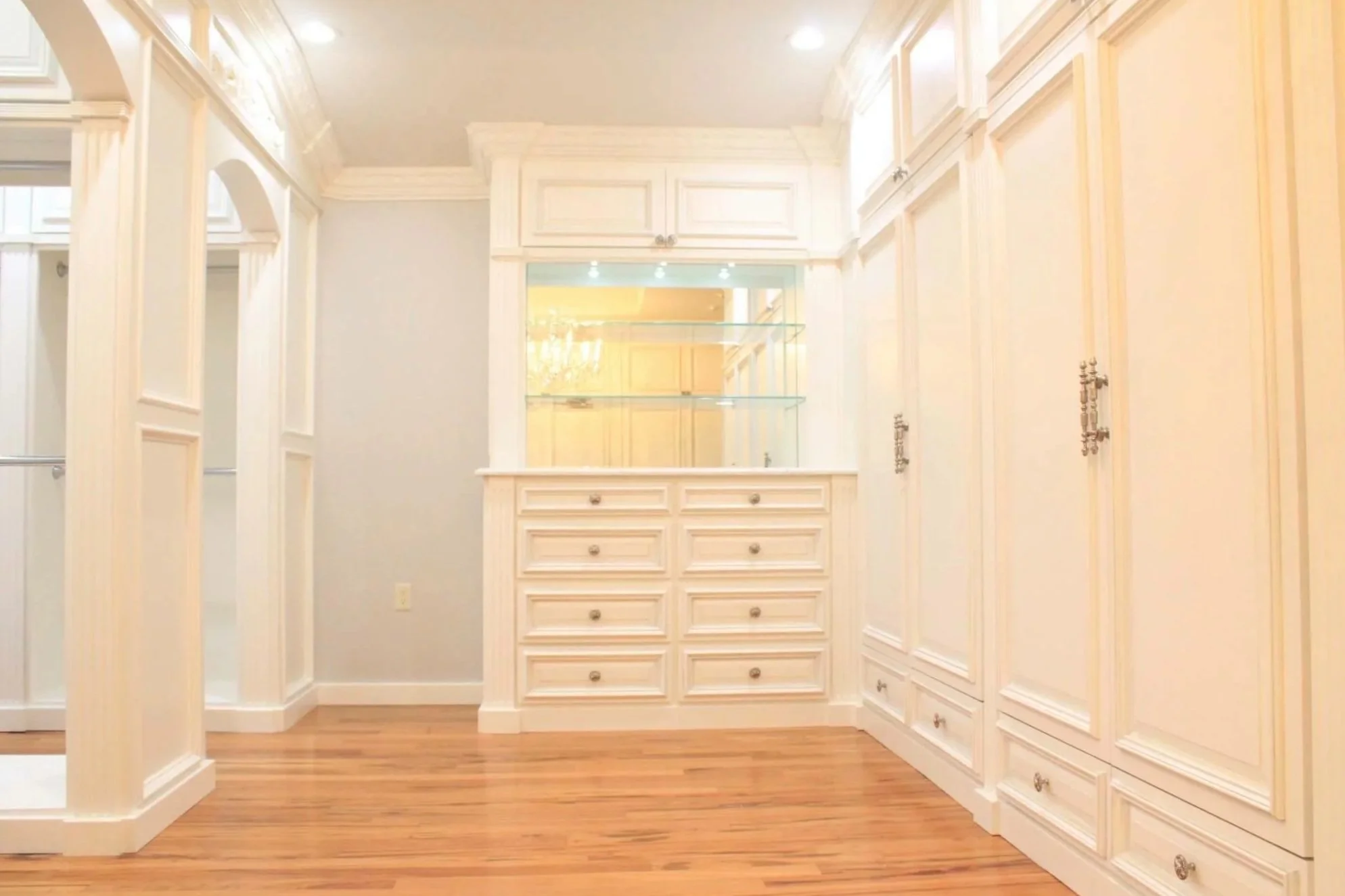 Center dresser anchors the closet with display shelving and concealed storage.