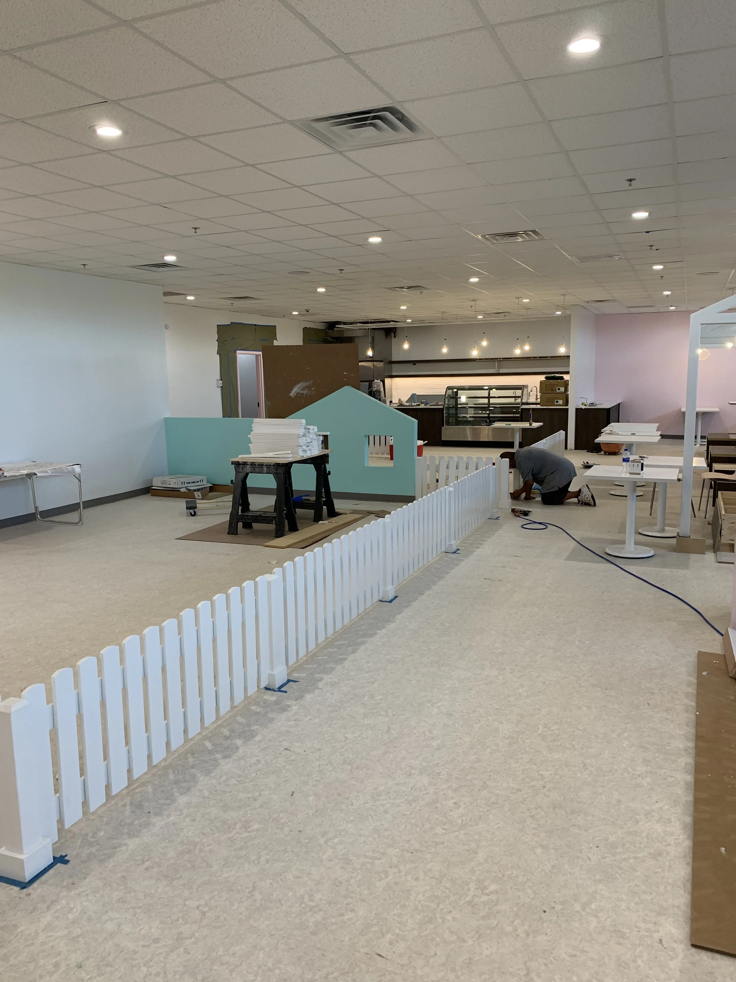 Tenant improvement adds child safe fencing and defined play areas in an open floor plan.