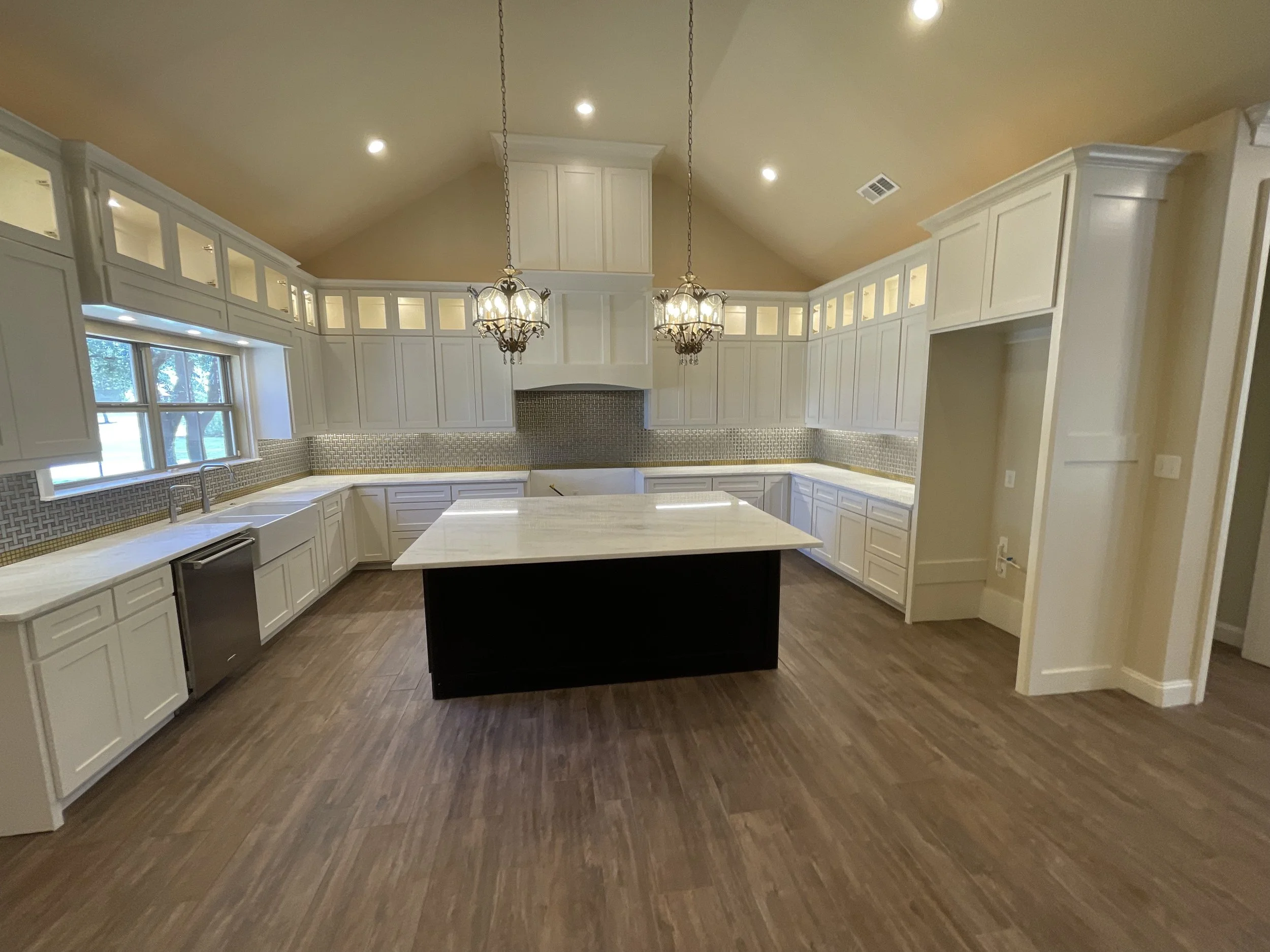 Expanded storage and statement lighting surround a central island.