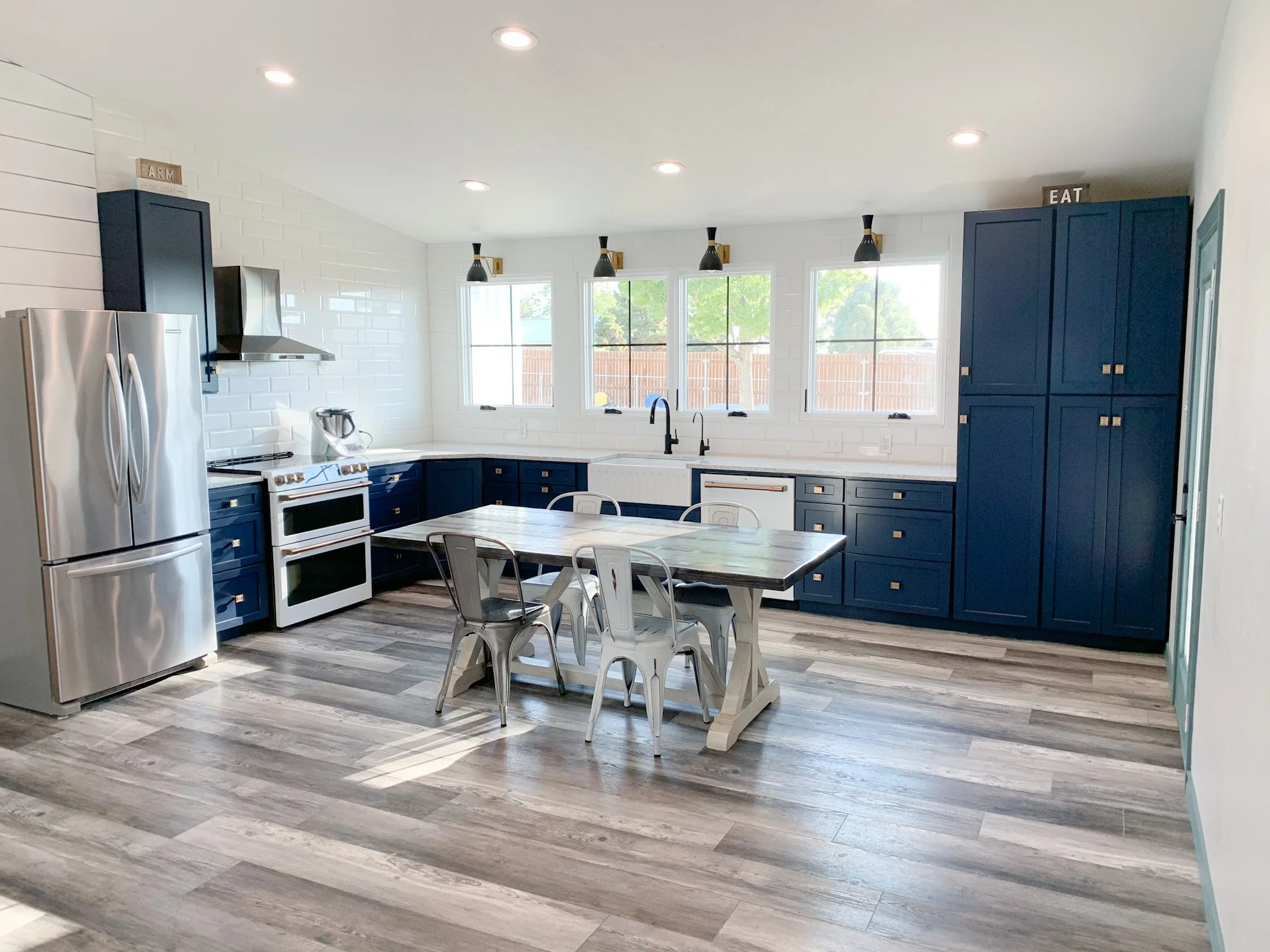 Family kitchen with durable plank flooring, new appliances, and ample natural light.