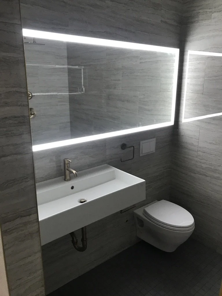 Clean lines and integrated lighting create a sleek bathroom.