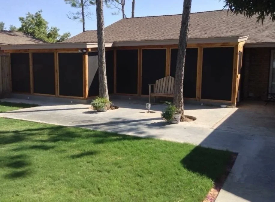 Screen panels and concrete patio create a shaded retreat.