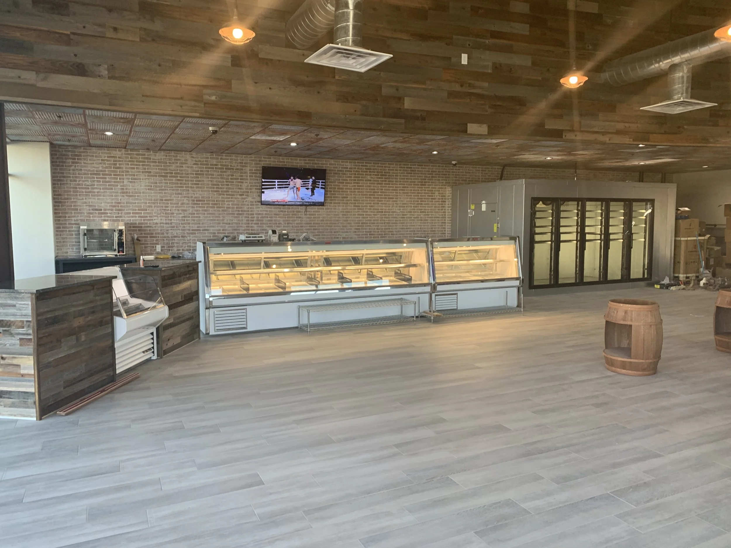 Lineup of refrigerated cases installed with service power and ventilation coordination.