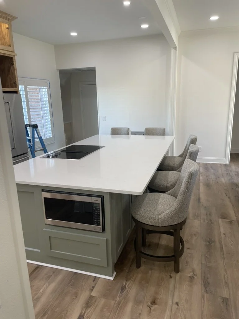 Family friendly island adds prep space and casual seating with an integrated microwave and new flooring.