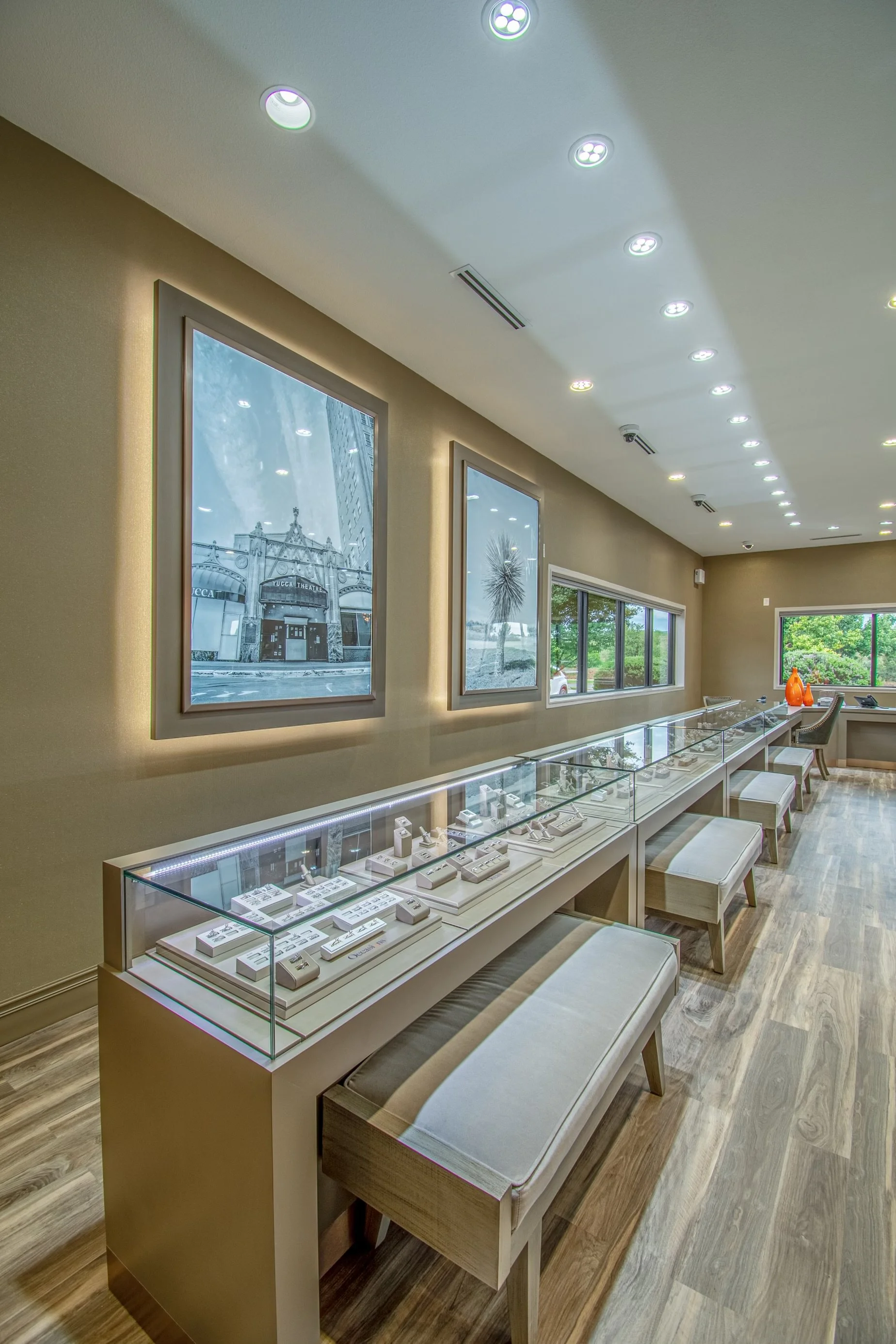 Perimeter display cases feature integrated accent lighting and comfortable client seating.