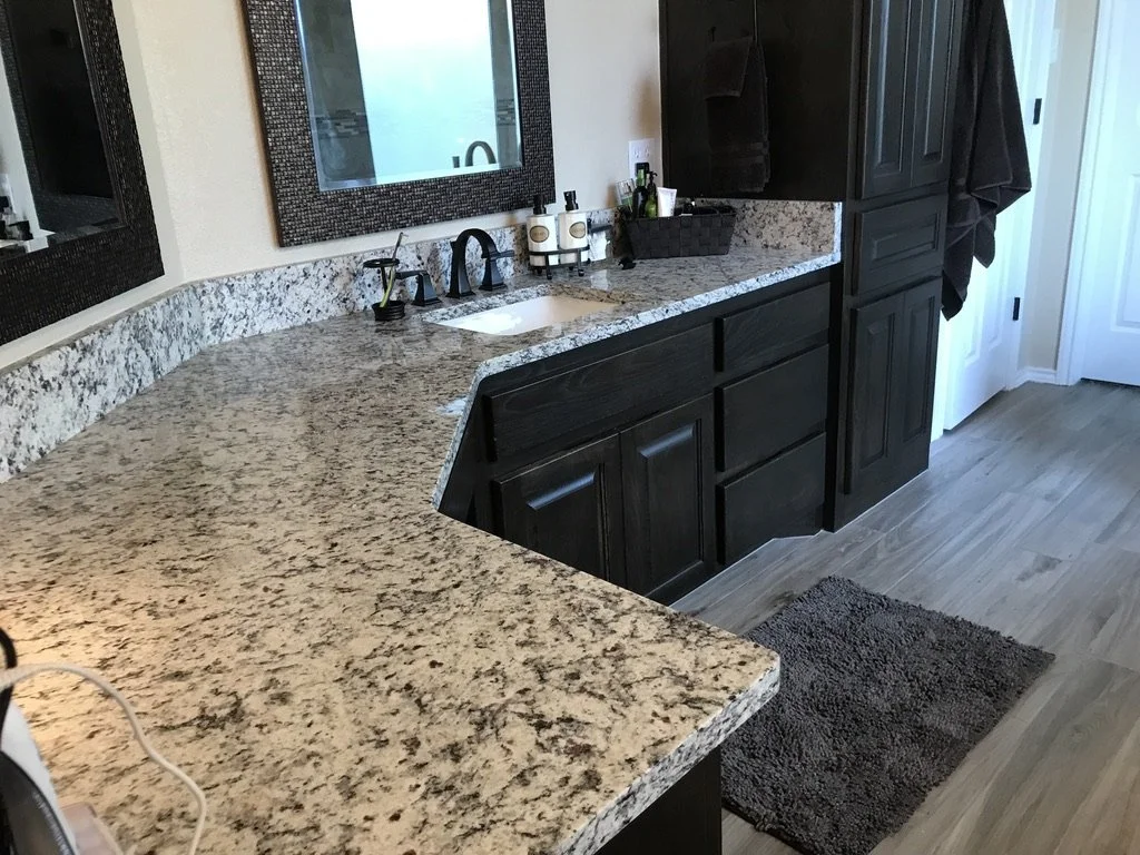 New cabinetry and hardware pair with stone tops for added storage and style.