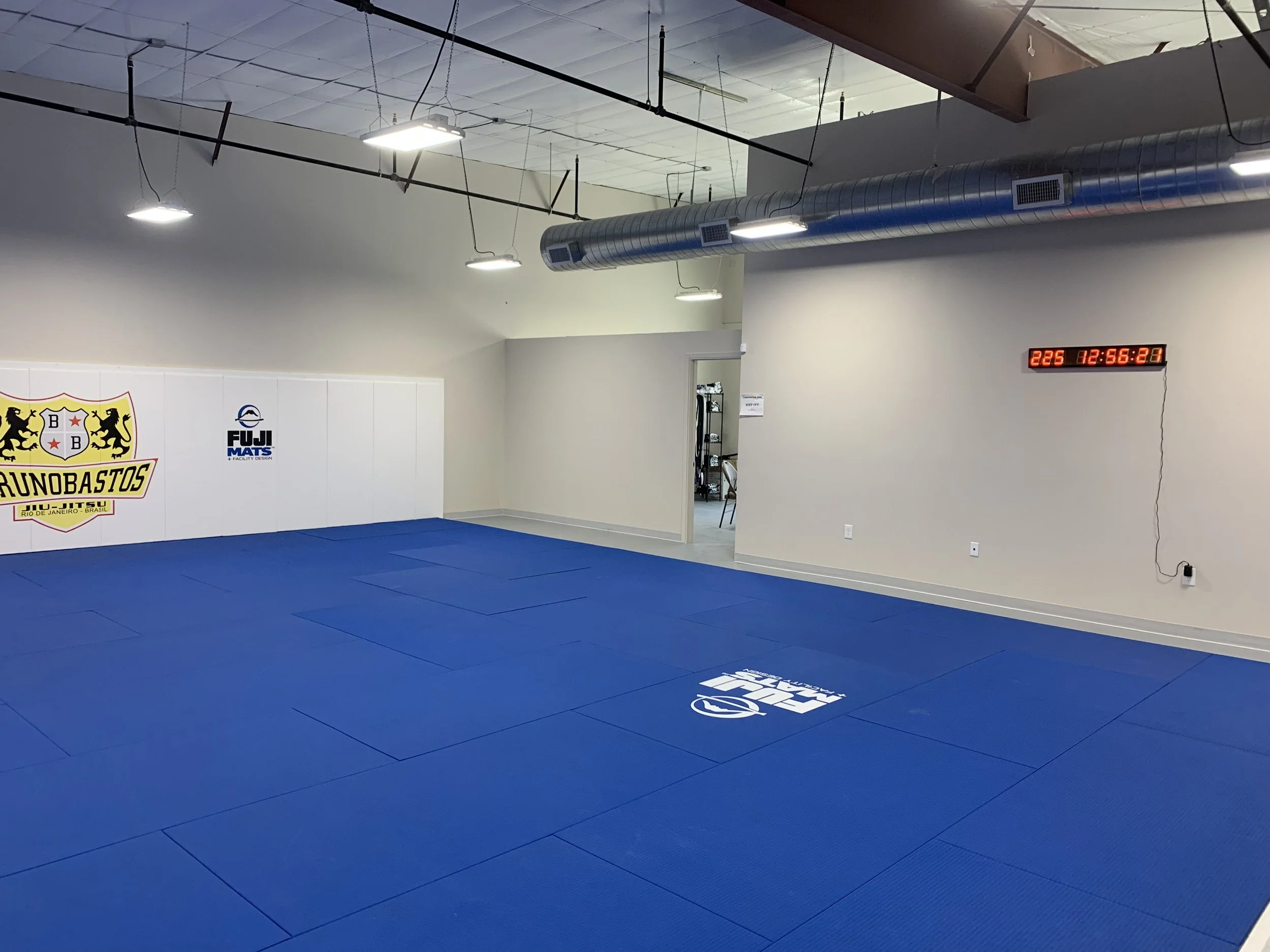 Corner perspective shows circulation to weight room and the integrated timer used for class rounds.