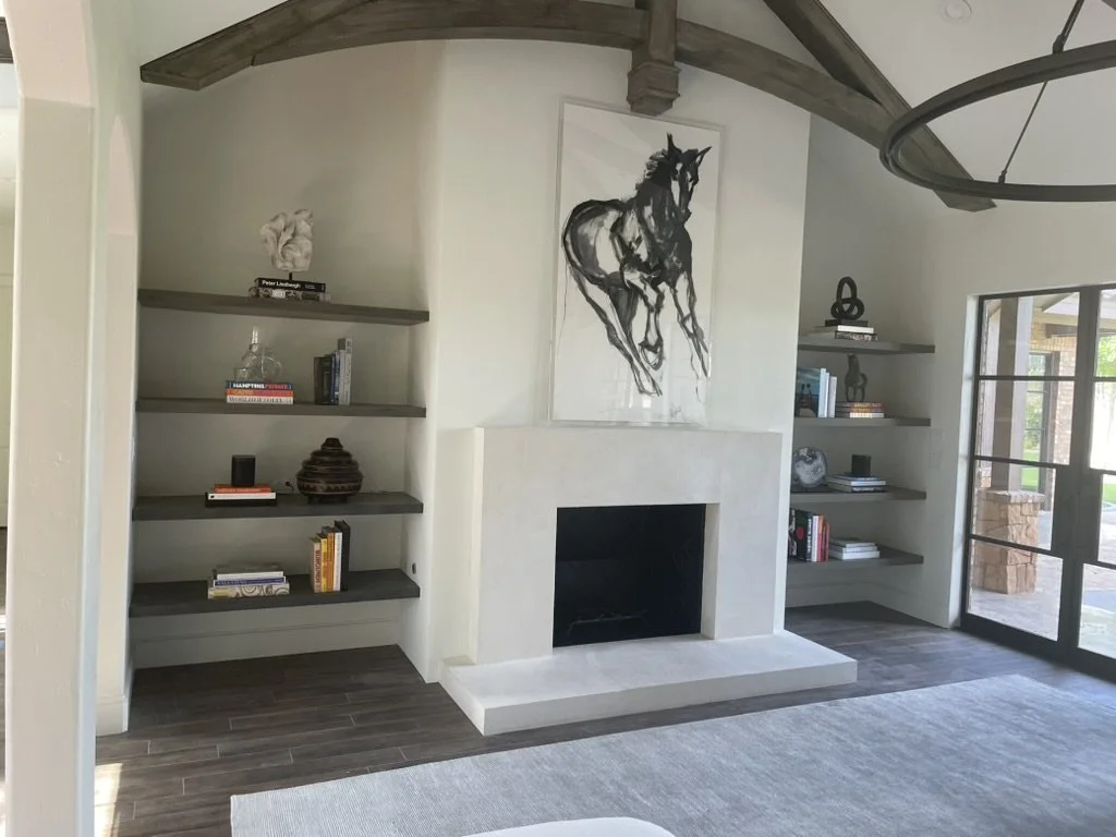 Living room fireplace and floating shelves.