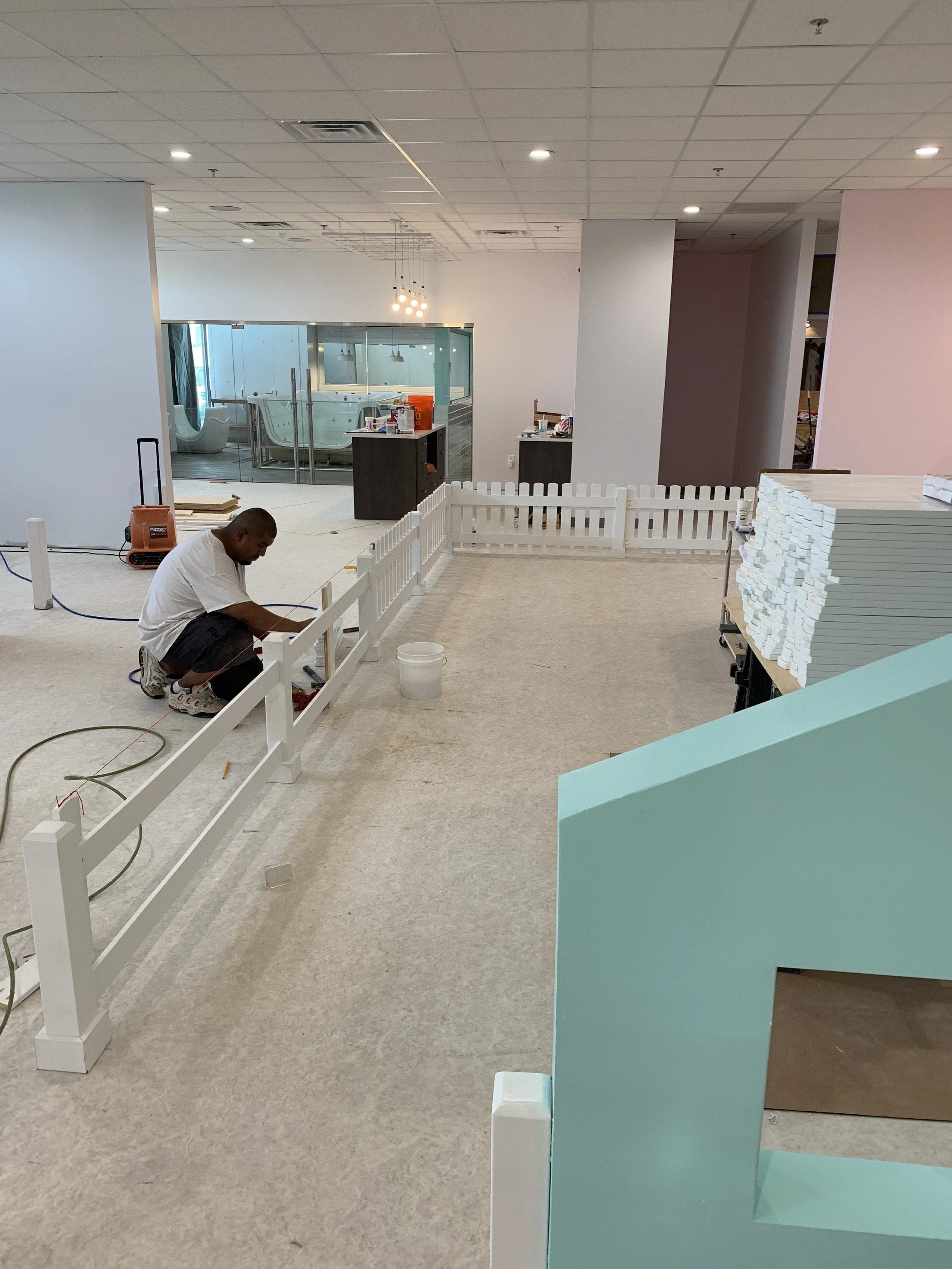 Interior picket fencing installation as part of a phased tenant improvement.