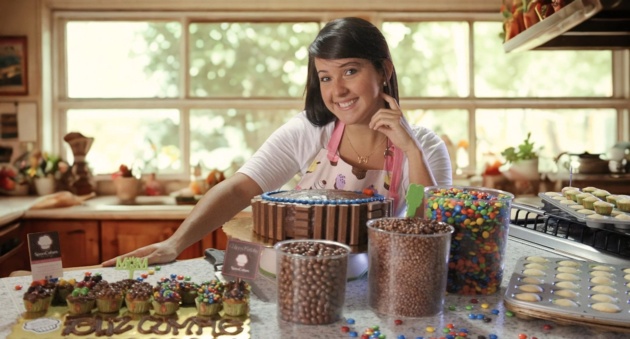 Alexandra, SponCakes Factory founder, in the early days of the business with handmade cupcakes and a custom cake