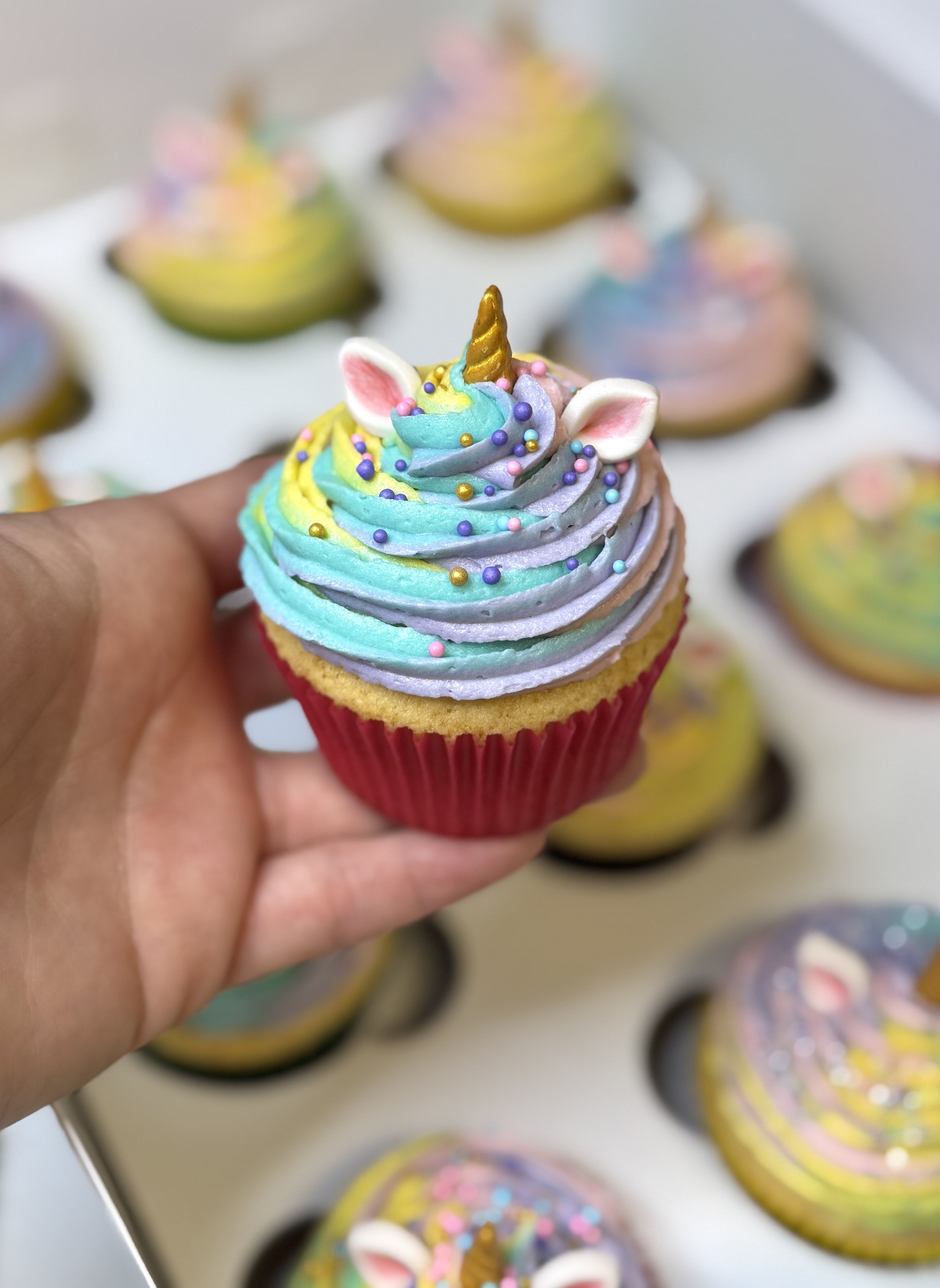 Unicorn-inspired classic cupcakes with pastel colours and edible decorations