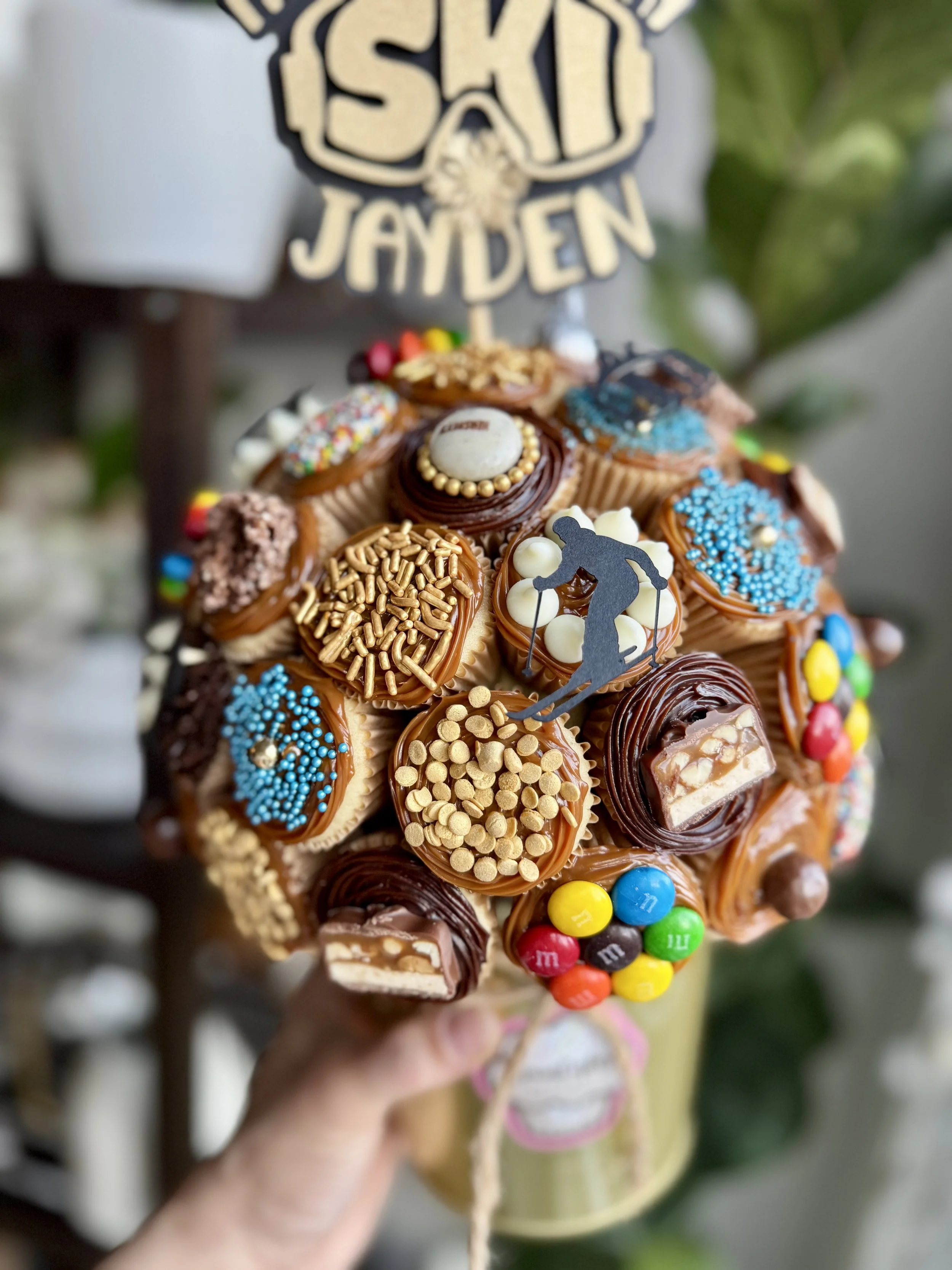 Custom mini cupcake bouquet with ski themed decorations