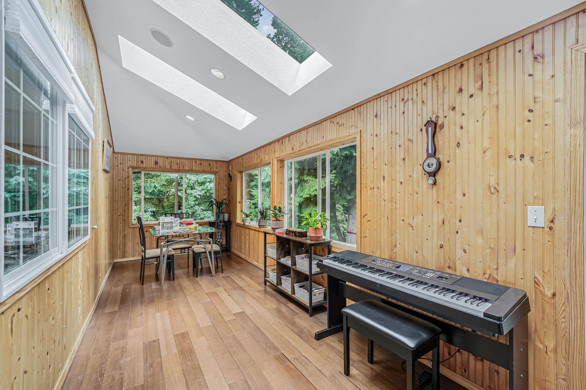 Bright sunroom with skylights and large windows, ideal for daily activities, games, and enjoying natural light.