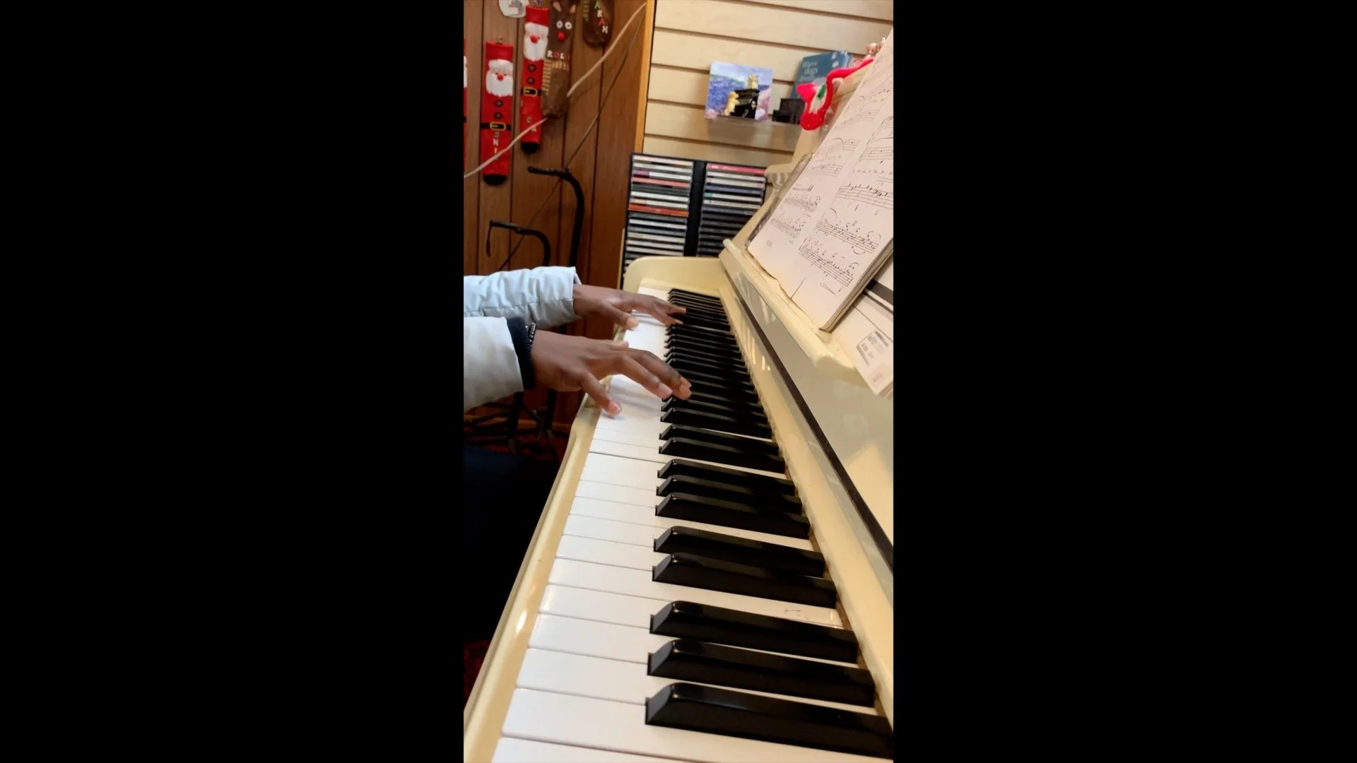 Close-up of a student’s hands practicing piano during a lesson
