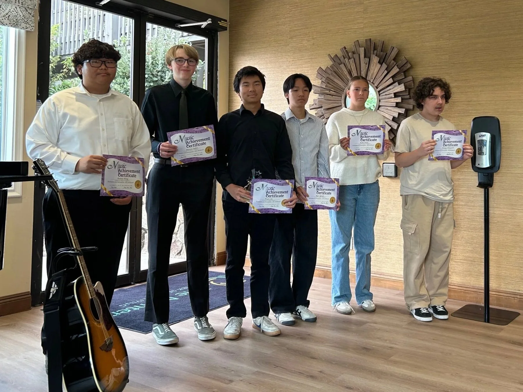 Students receiving music achievement certificates at a San Diego piano recital at Lovley Piano Studio